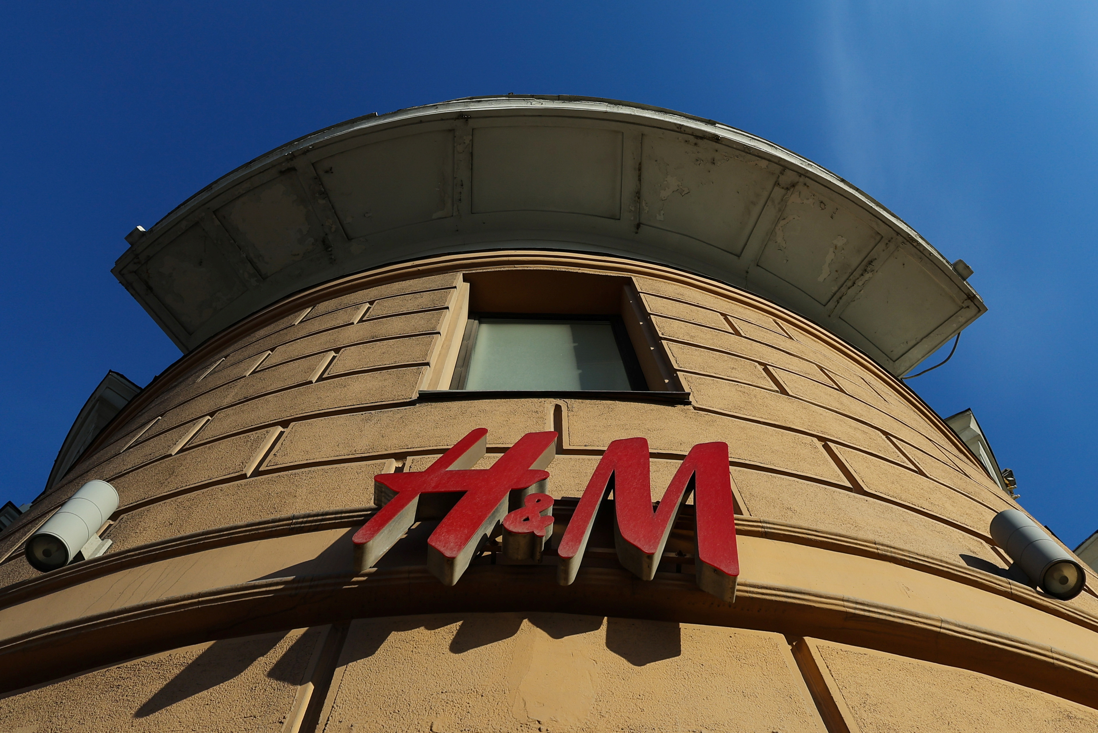 The logo of H&M is seen at a closed store in Moscow