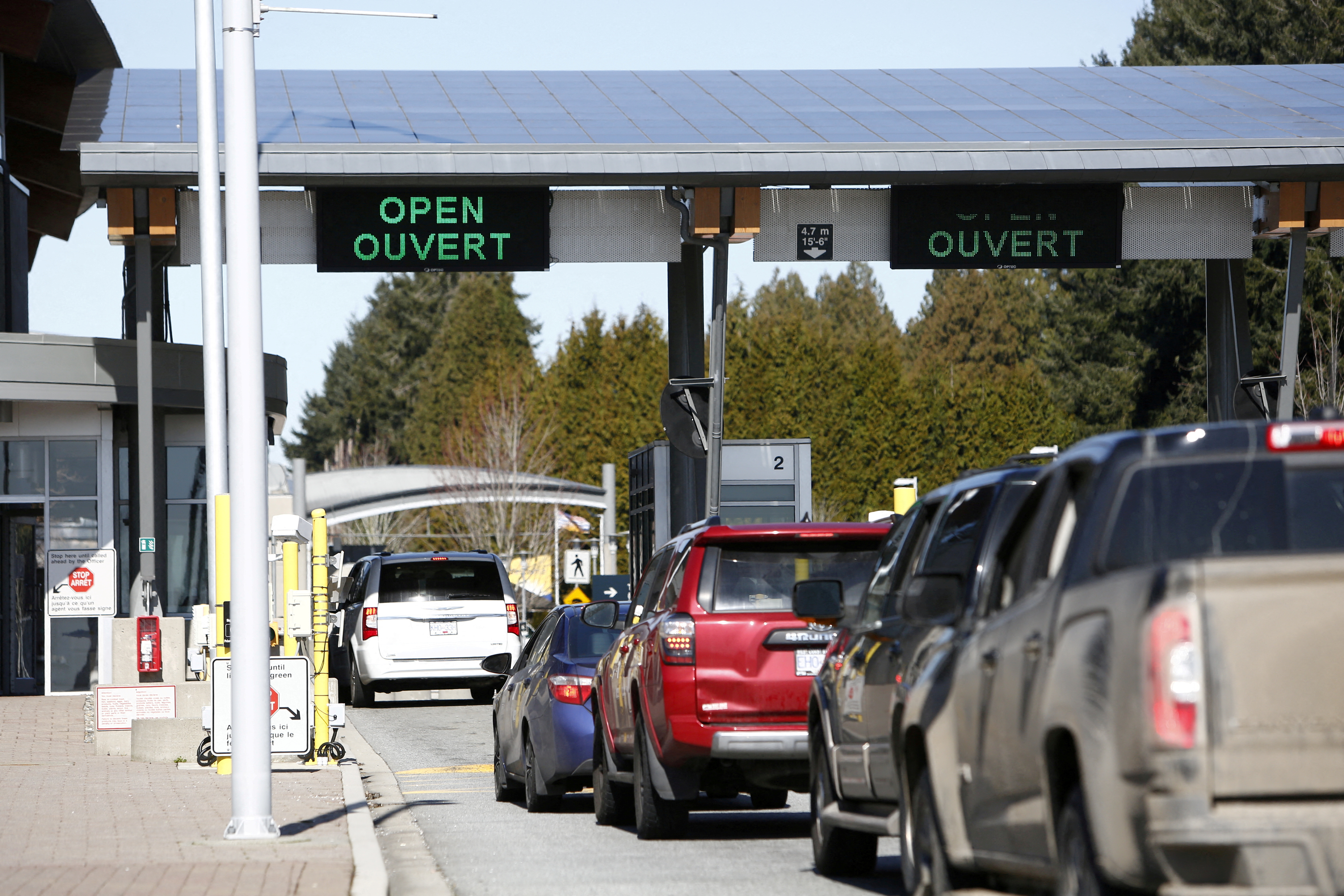 FILE PHOTO: Drivers wait to cross through Canadian customs at the Canada-US border near the Peace Arch Provincial Park