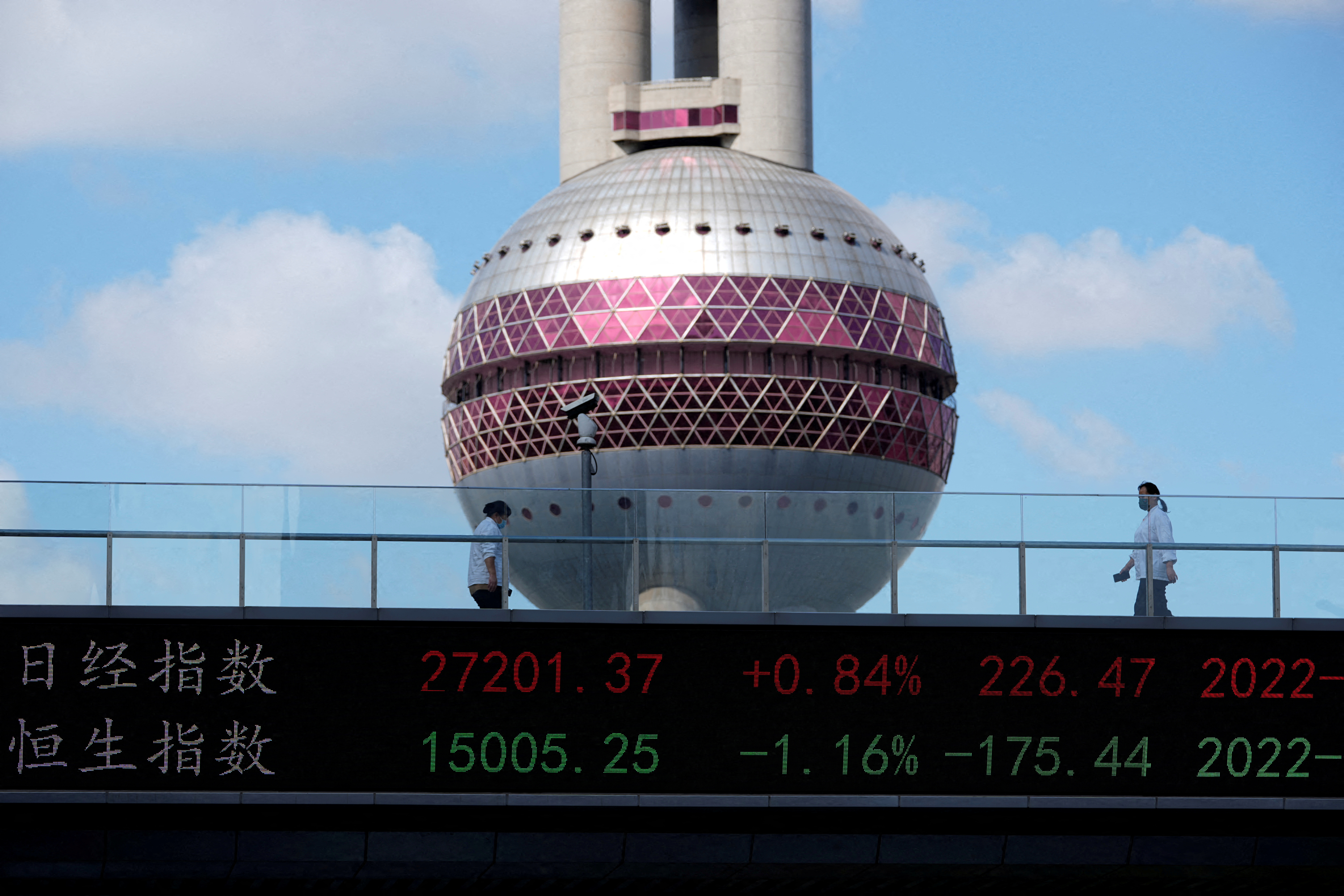 An electronic board shows Hang Seng stock index in Shanghai
