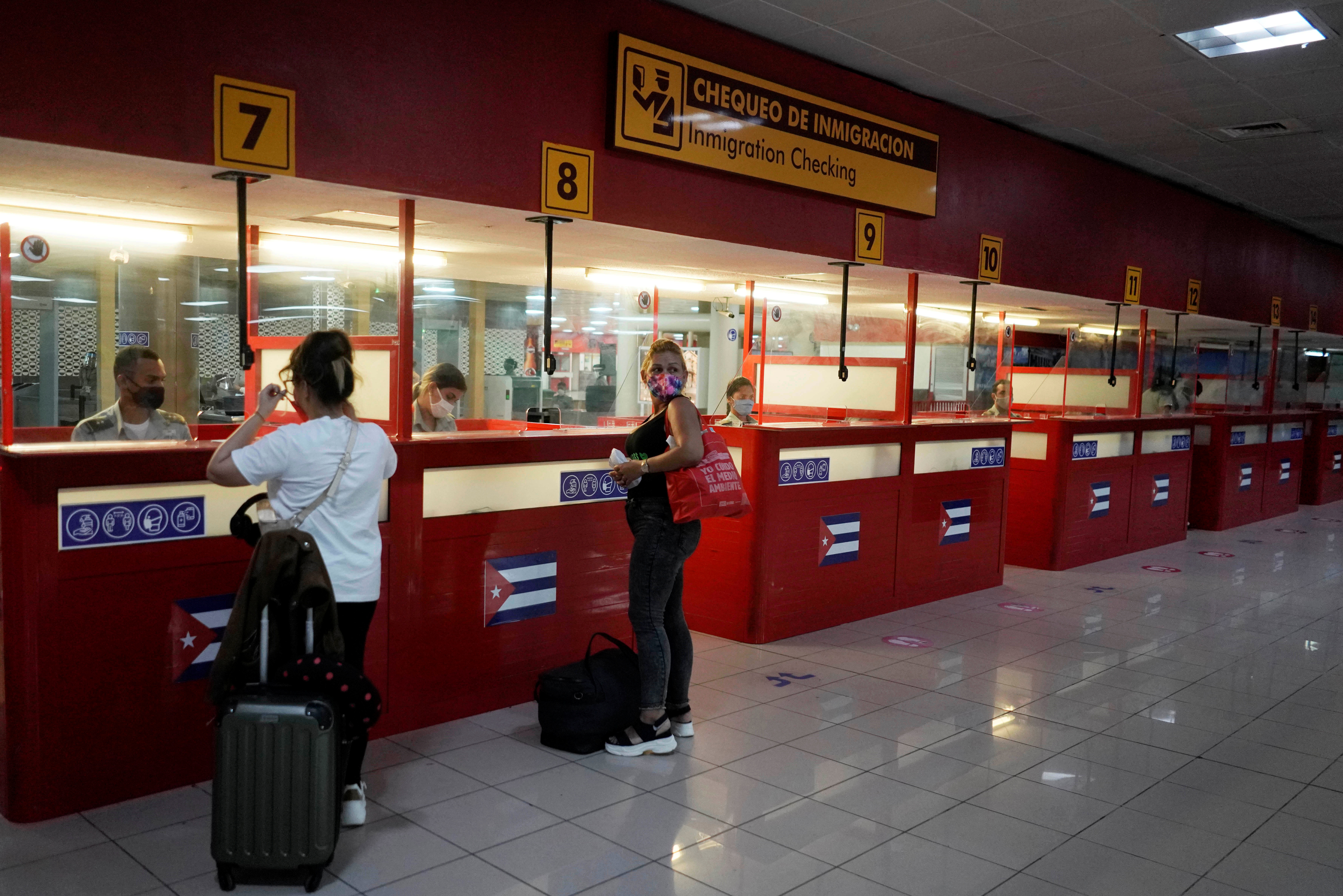 Tourists have their passports checked at the Jose Marti International Airport amid concerns about the spread of the coronavirus disease (COVID-19), in Havana, Cuba, November 15, 2020. REUTERS/Alexandre Meneghini