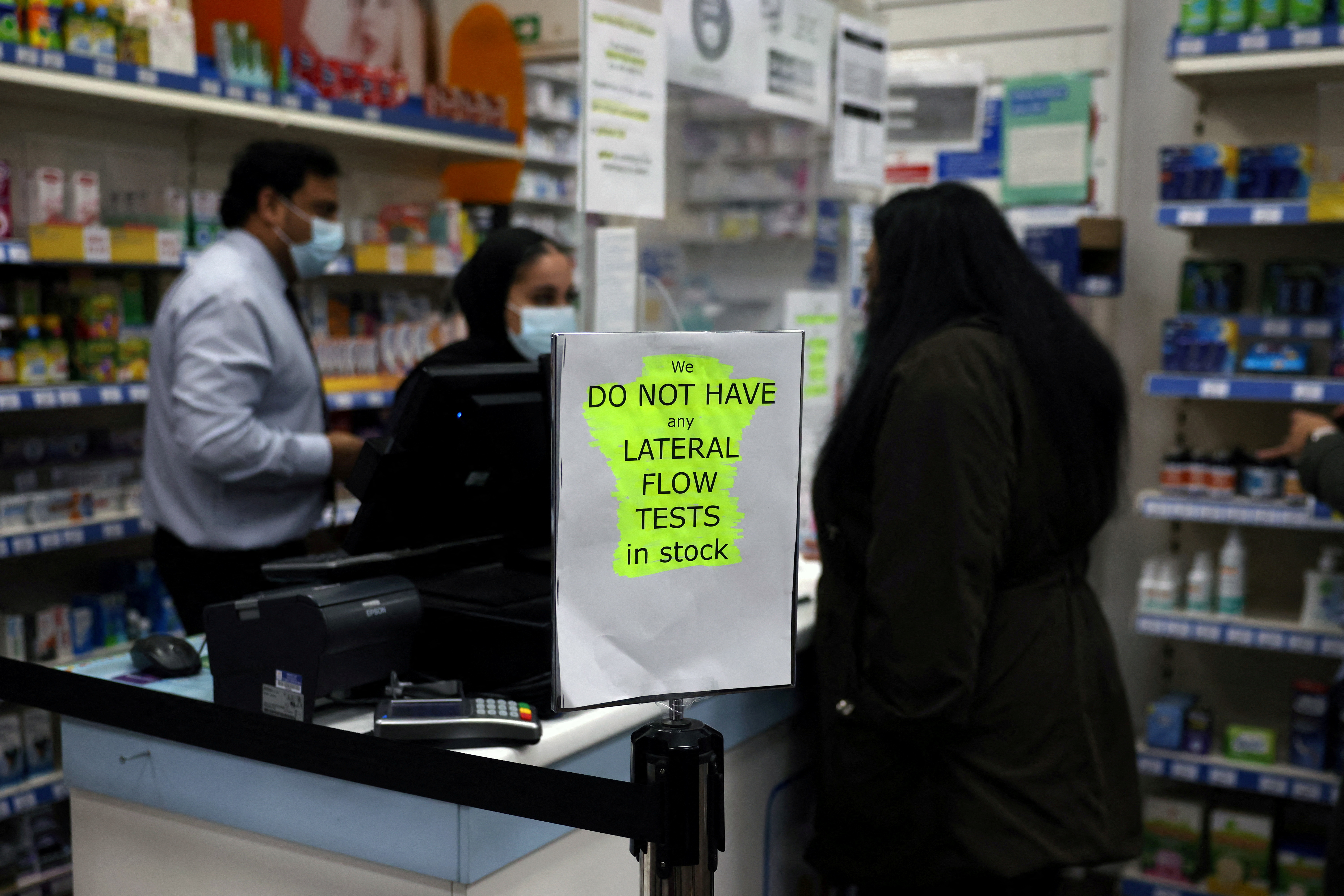 A sign informing customers that lateral flow tests are out of stock is seen at a pharmacy in London