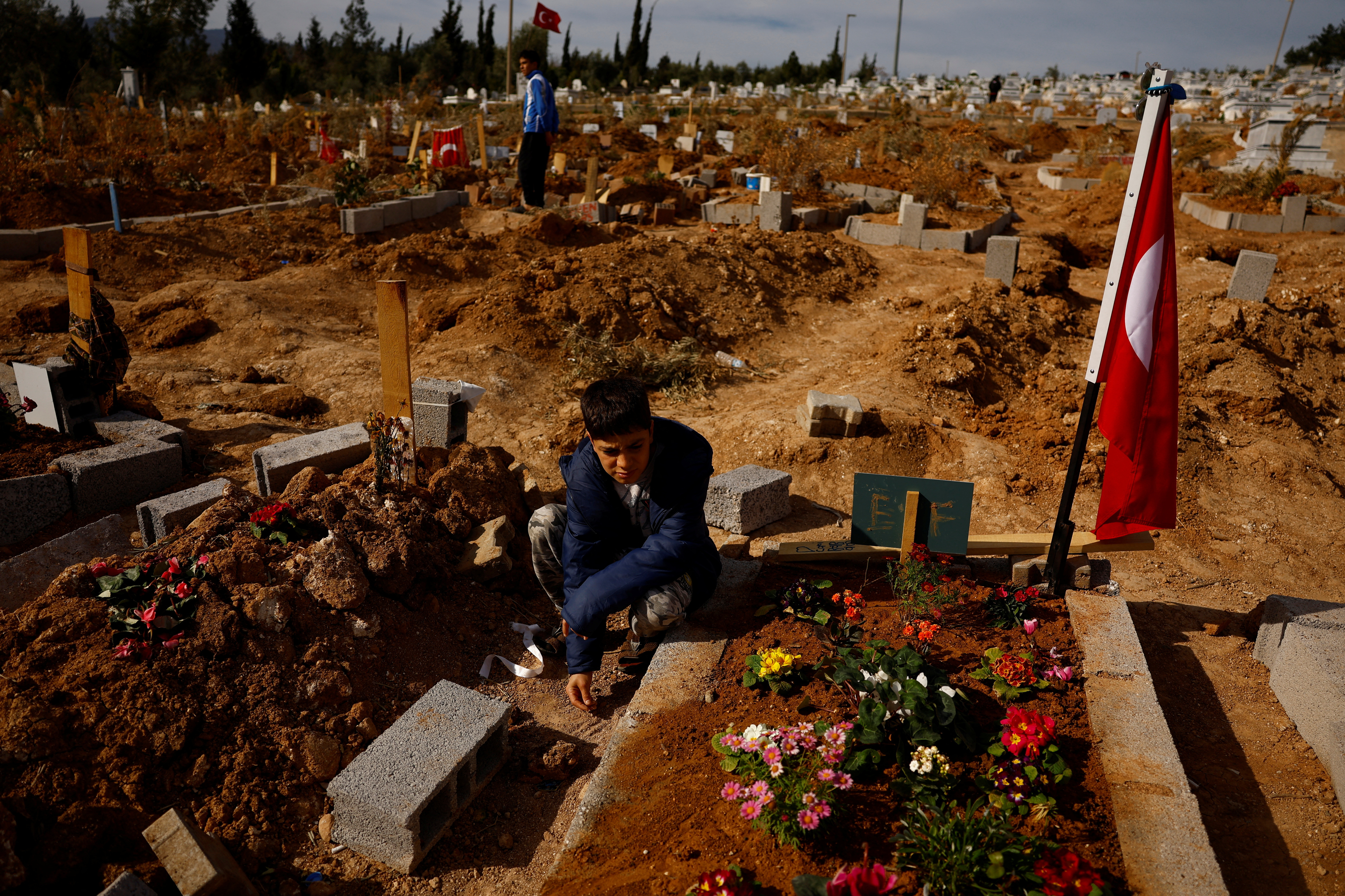 The Wider Image: Turkish undertaker's family move to cemetery as he buries earthquake dead