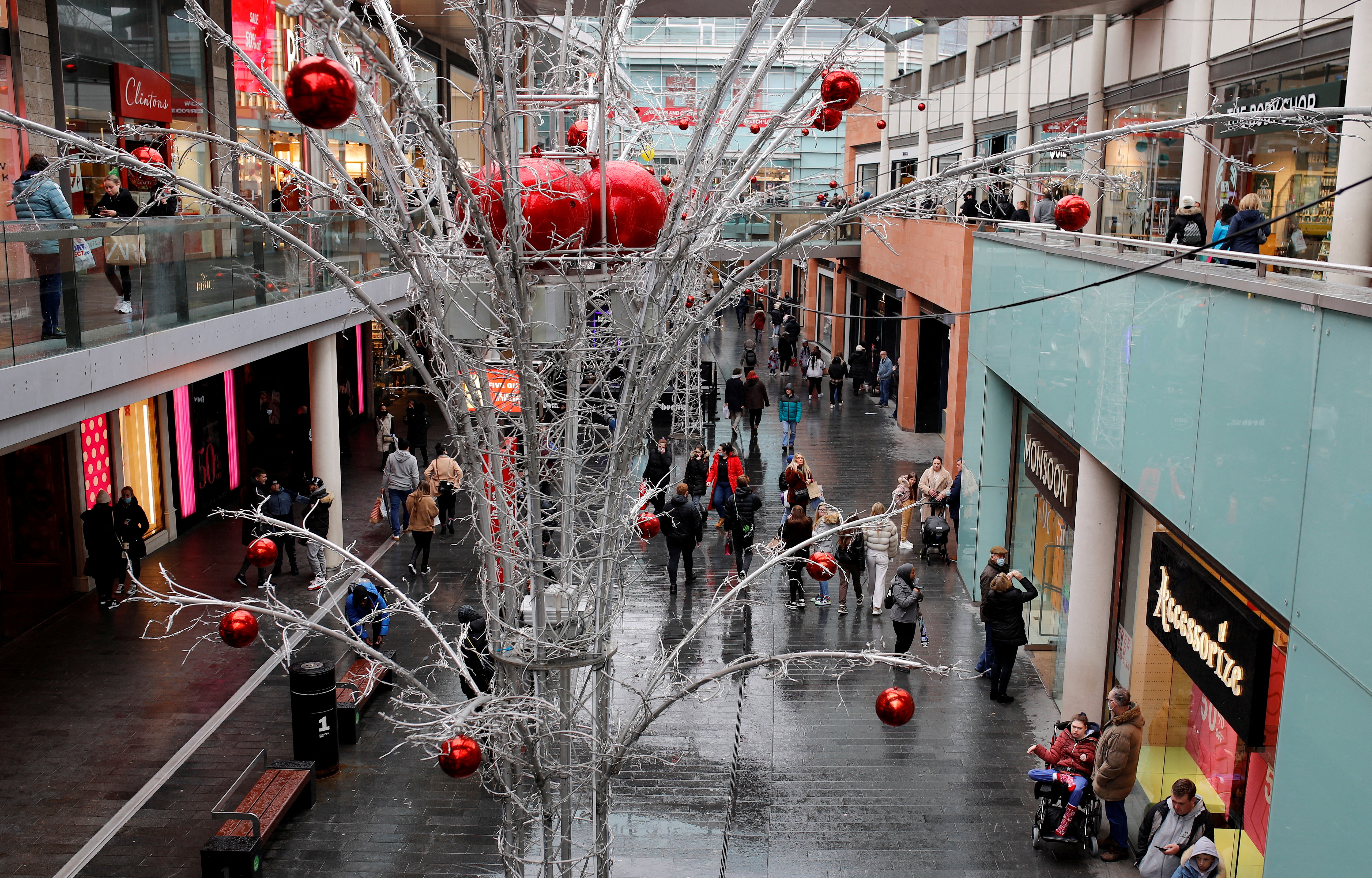 People carry shopping bags as they look for bargains in the traditional Boxing Day sales in Liverpool