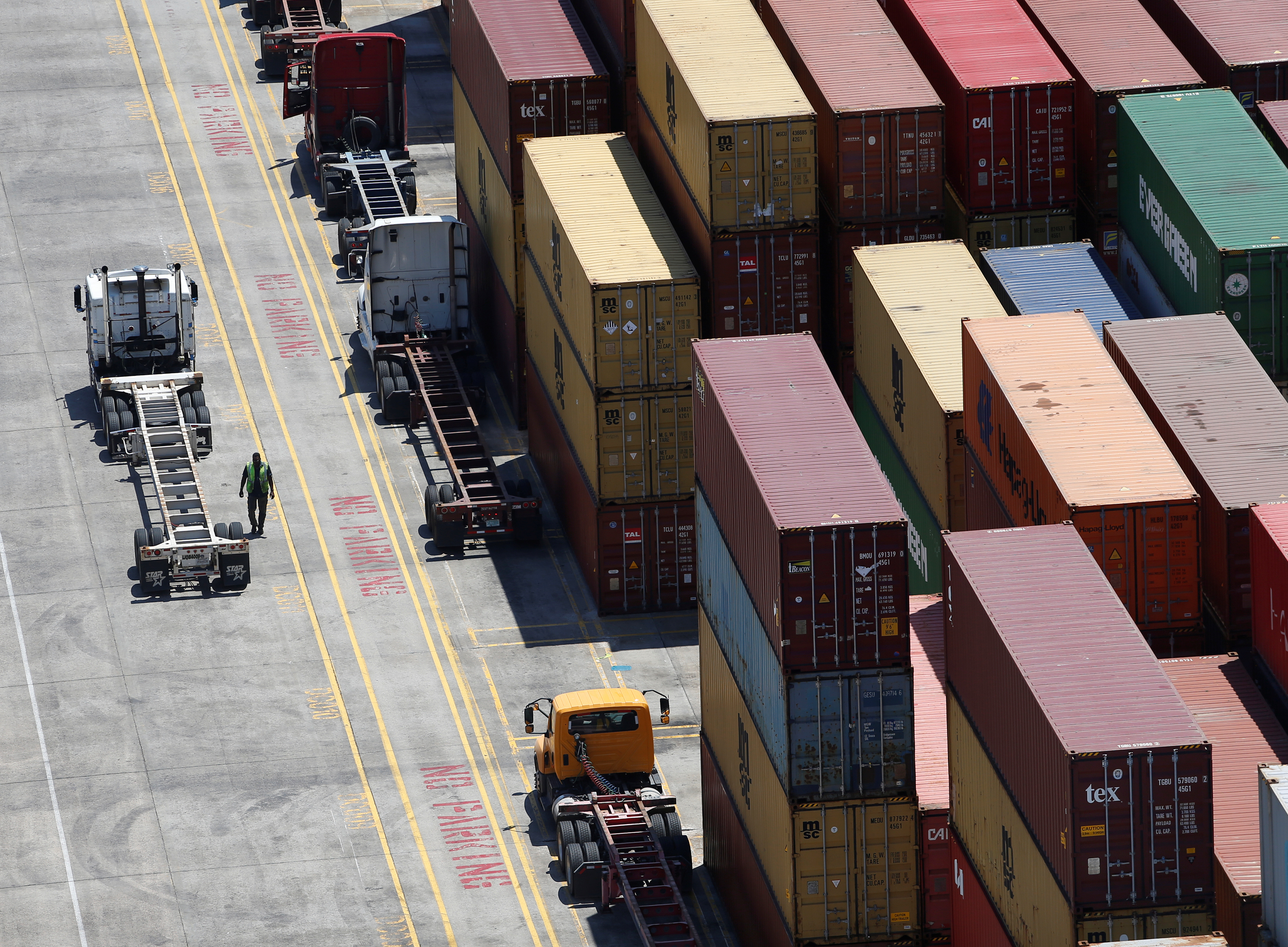 Workers stack empty shipping containers for storage at Wando Welch Terminal operated by the South Carolina Ports Authority in Mount Pleasant
