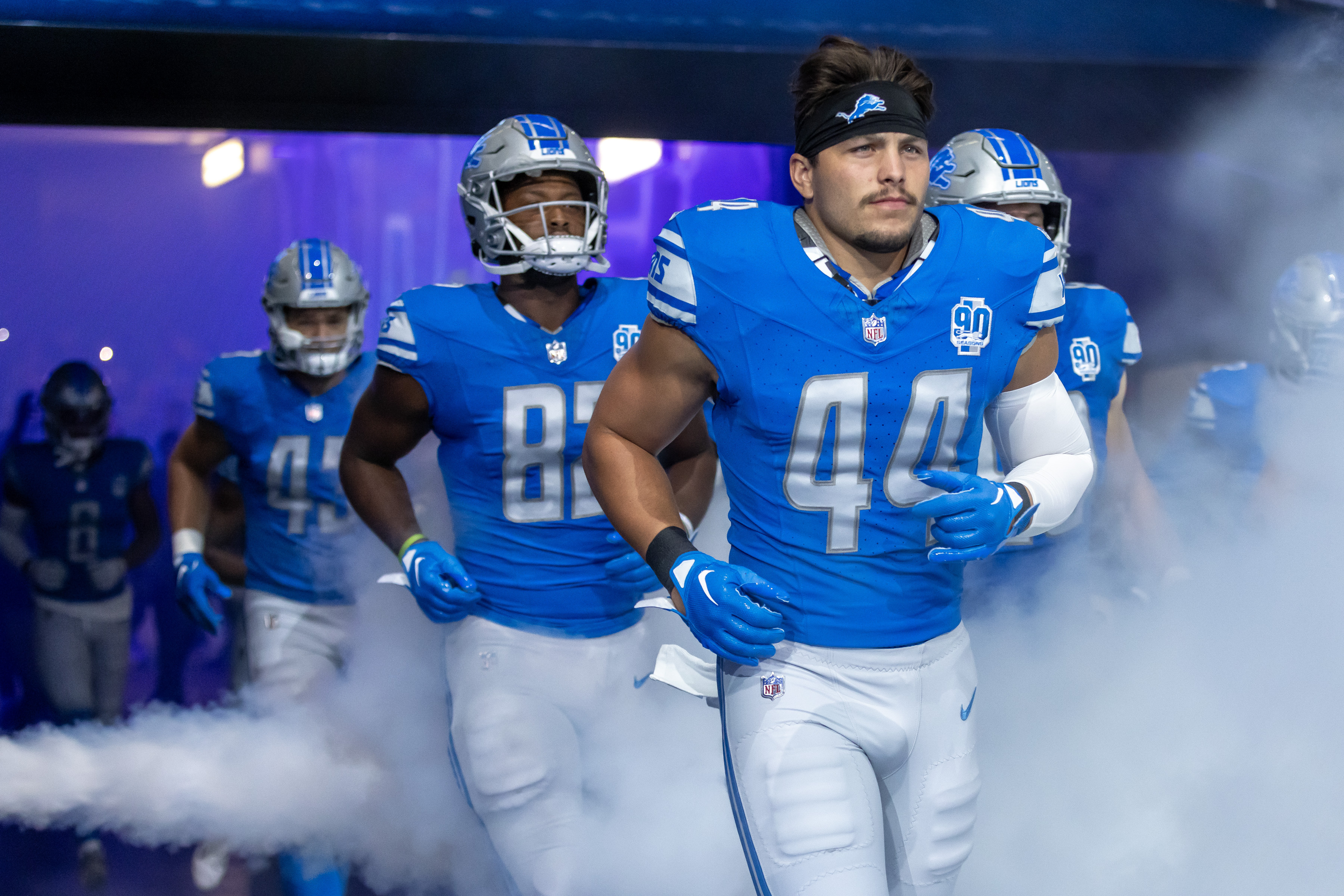 Detroit Lions quarterback Adrian Martinez (18) avoids New York Giants  linebacker Habakkuk Baldonado (45) while carrying the ball during the  second half of an NFL preseason football game, Friday, Aug. 11, 2023