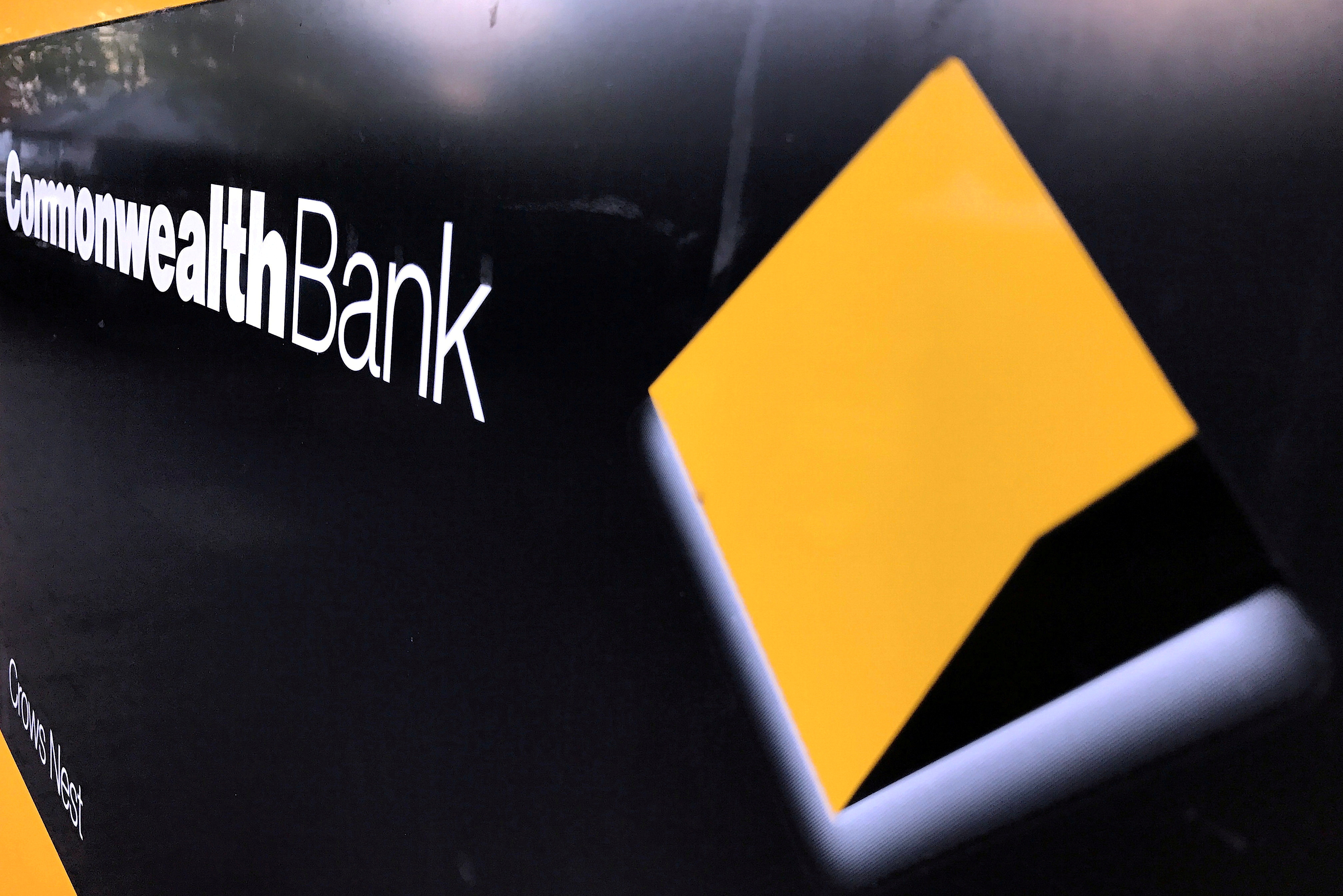 A Commonwealth Bank of Australia logo adorns the wall of a branch in Sydney, Australia