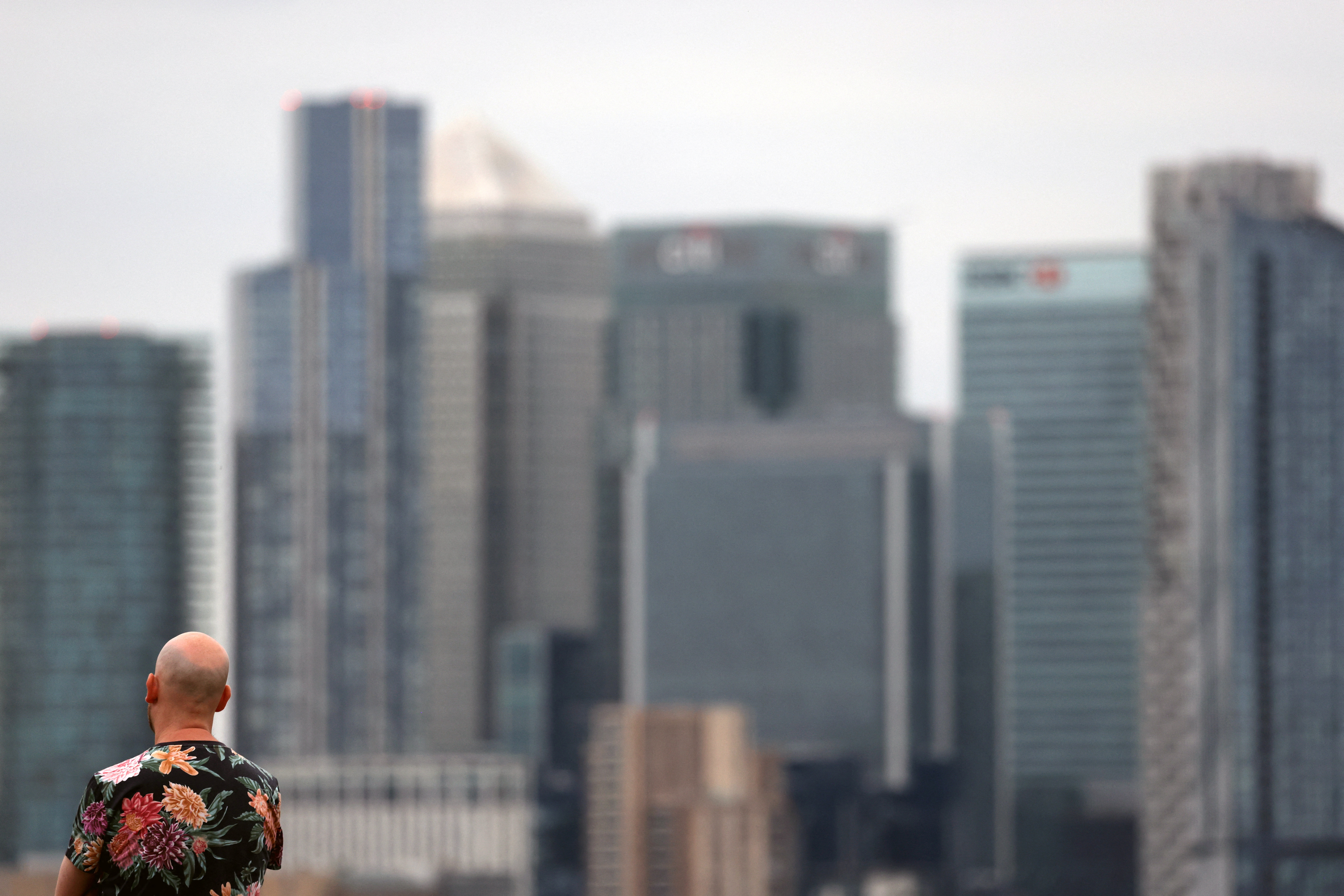 A man looks towards Canary Wharf financial district