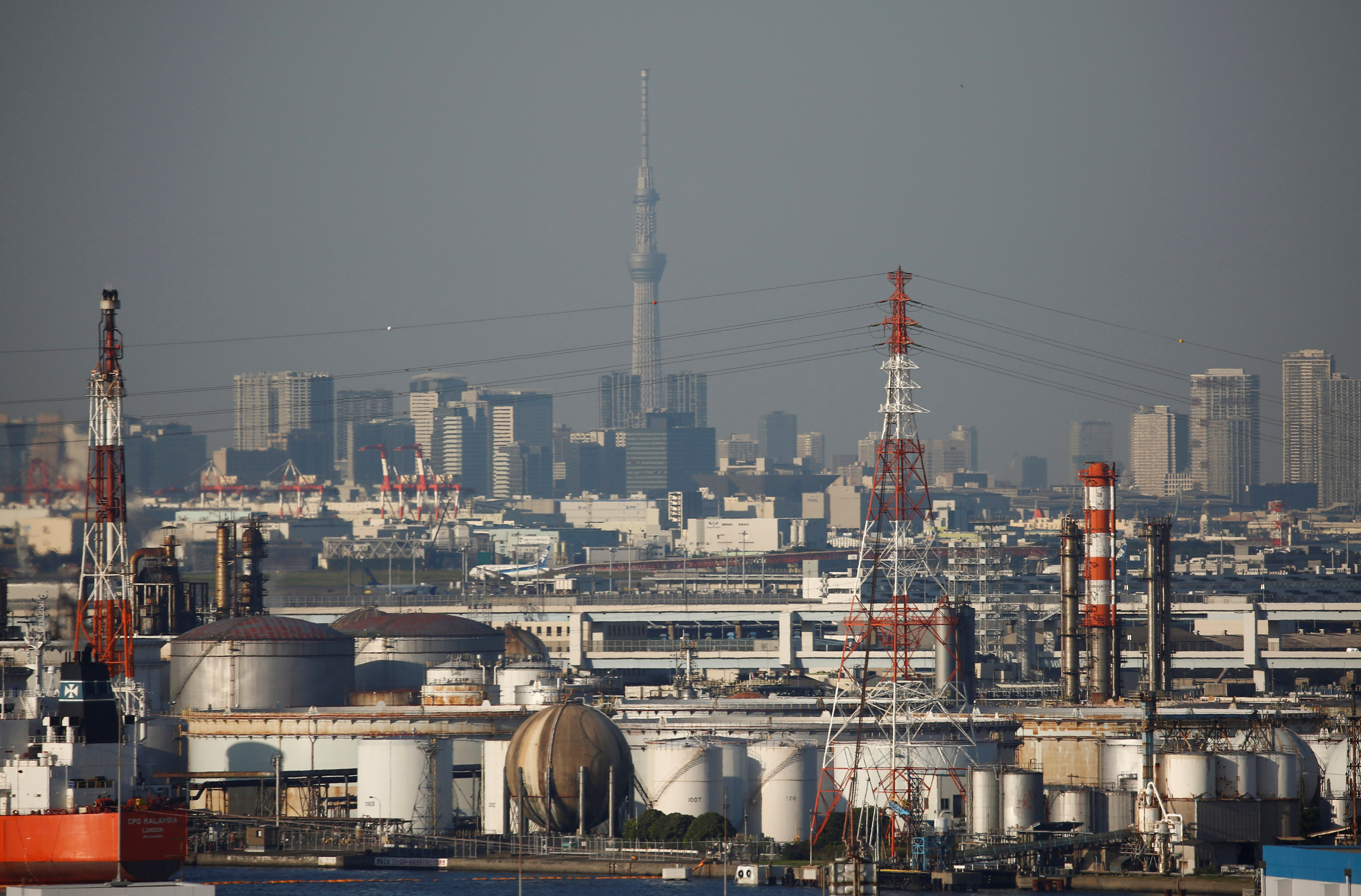 Chimneys of an industrial complex and Tokyo's skyline are seen from an observatory deck at an industrial port in Kawasaki