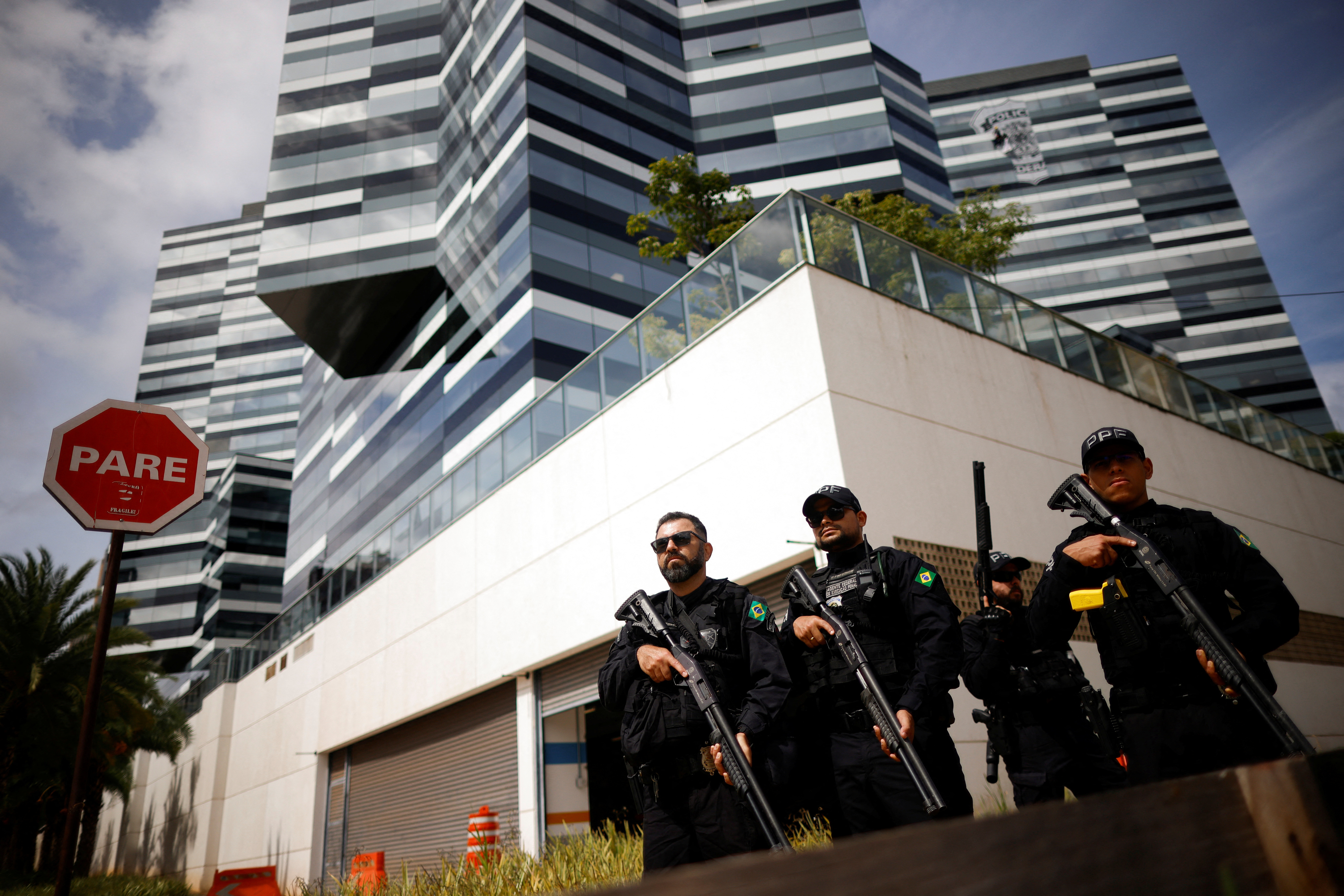 Federal prison officers take position in front of federal police headquarters during an action by Federal Police and agents of the Civil Police of Brasilia, to serve arrests and seizure warrants issued by the Federal Supreme Court in Brasilia