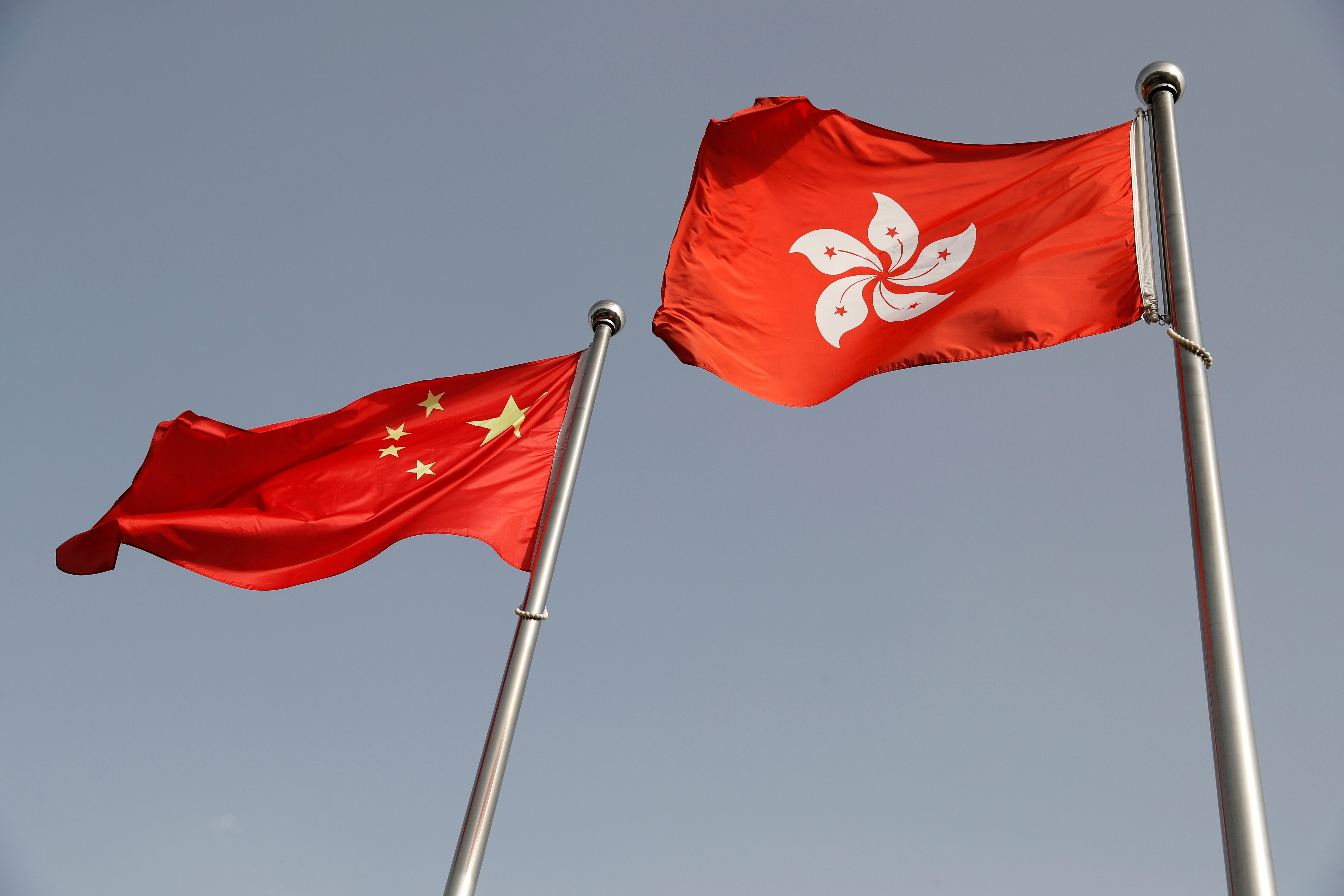 The Chinese and Hong Kong flags flutter at the office of the Government of the Hong Kong Special Administrative Region, ahead of a news conference held by Hong Kong Chief Executive Carrie Lam, in Beijing