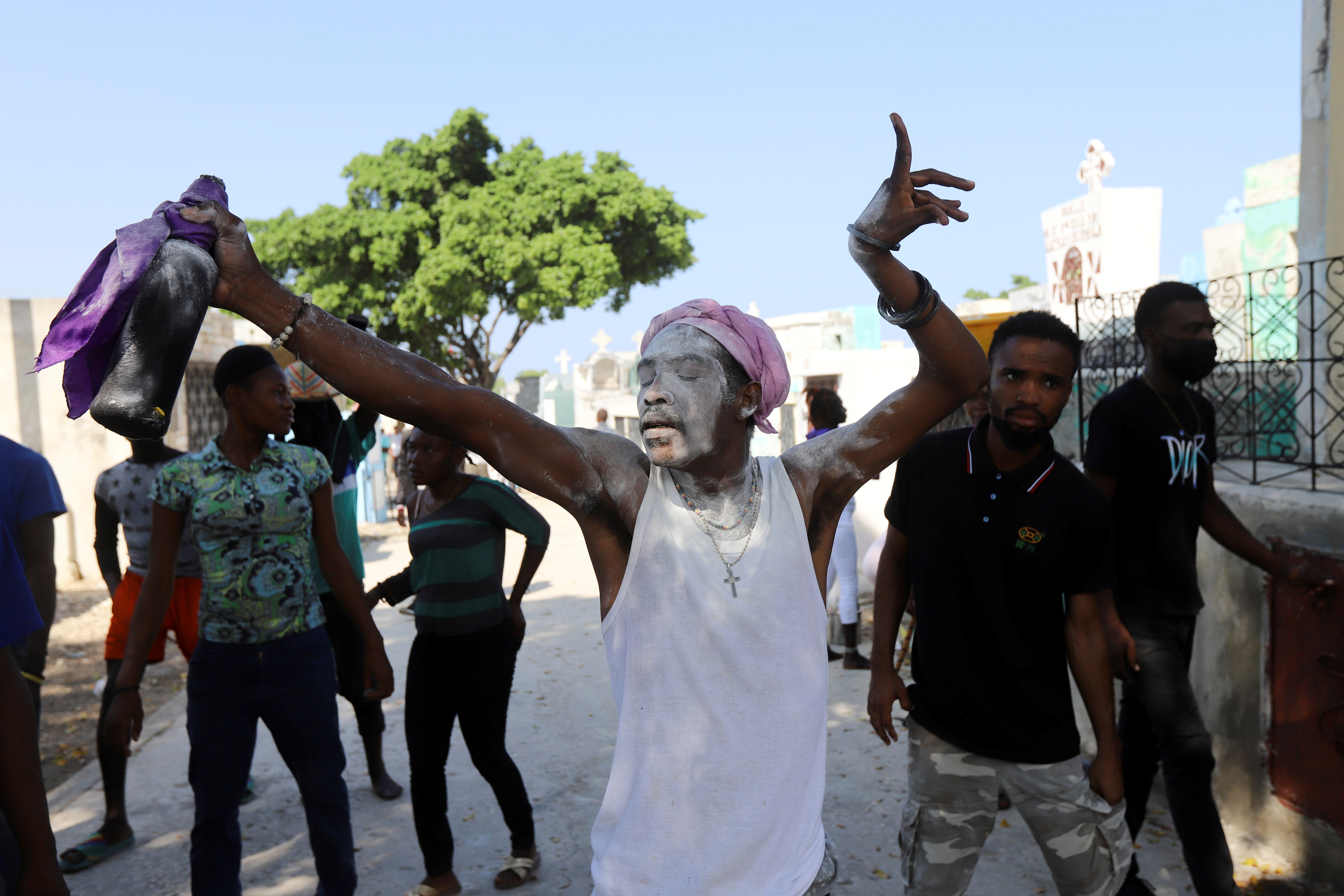 A man with powder on his face dances during Day of the Dead celebrations at a cemetery, in Port-au-Prince, Haiti November 1, 2021. REUTERS/Ralph Tedy Erol