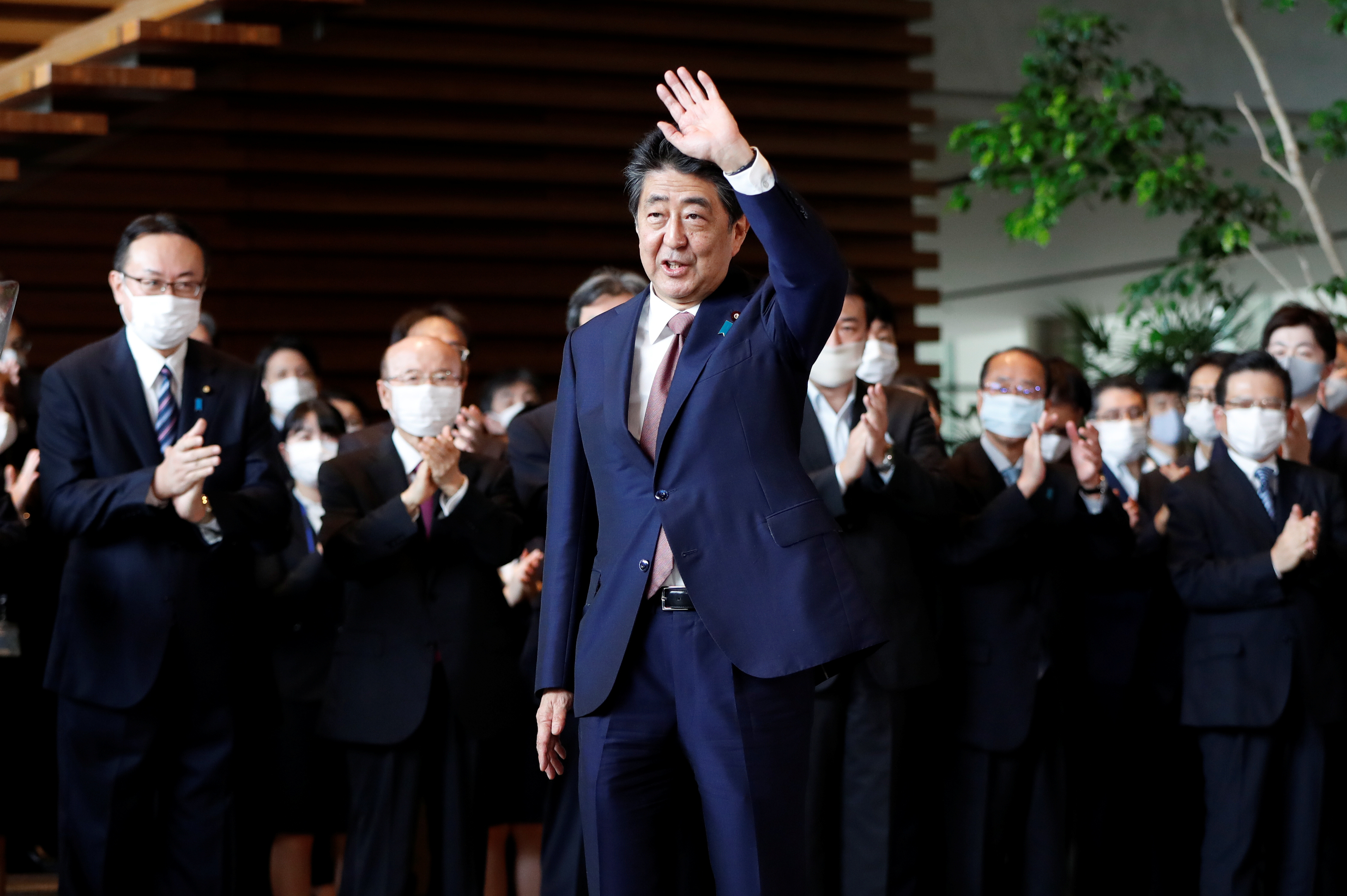 Japan's outgoing PM Shinzo Abe leaves his official residence in Tokyo