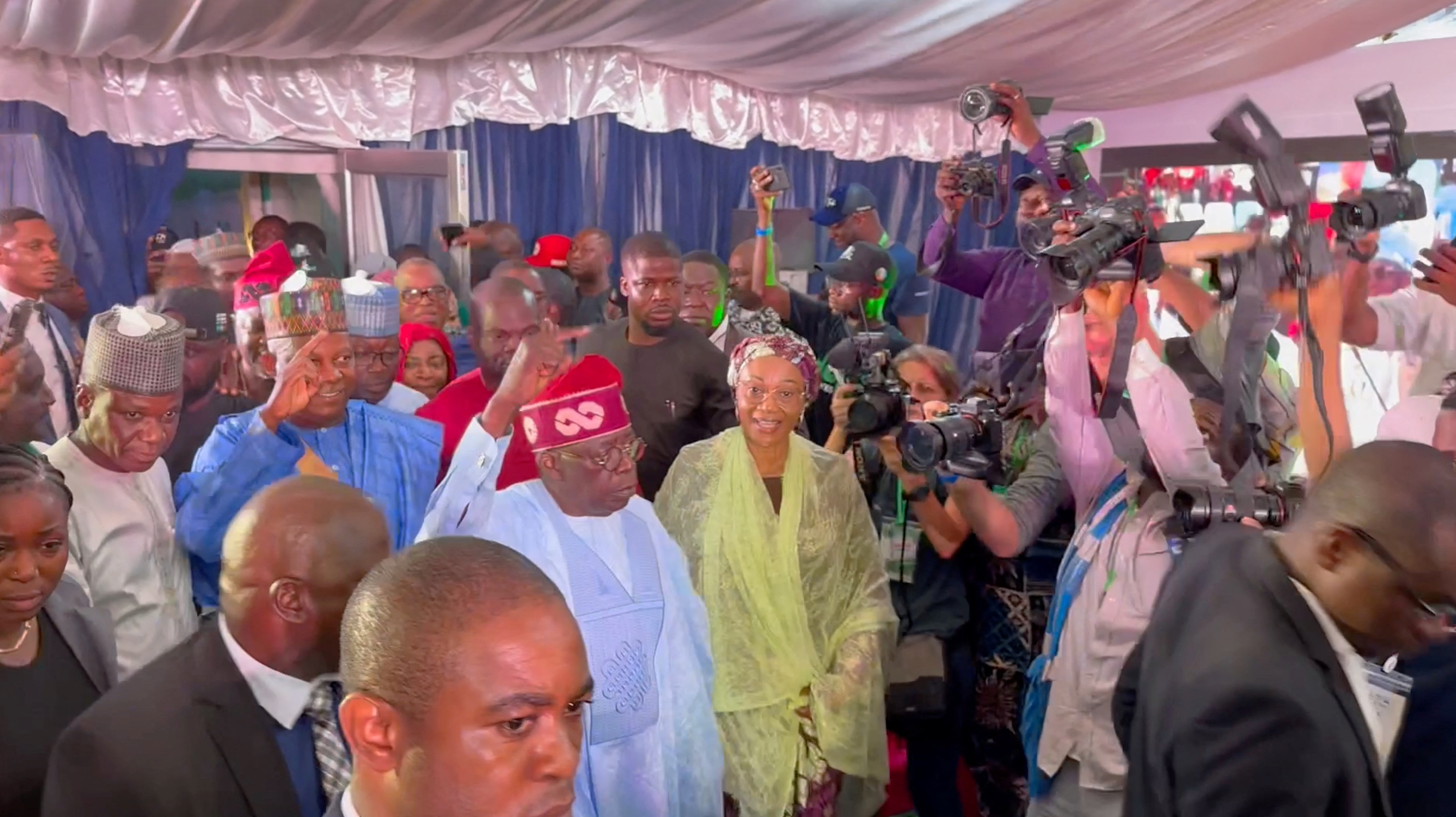 Bola Tinubu gestures at the people crowding around him, after he was declared winner in Nigeria's presidential election, in Abuja