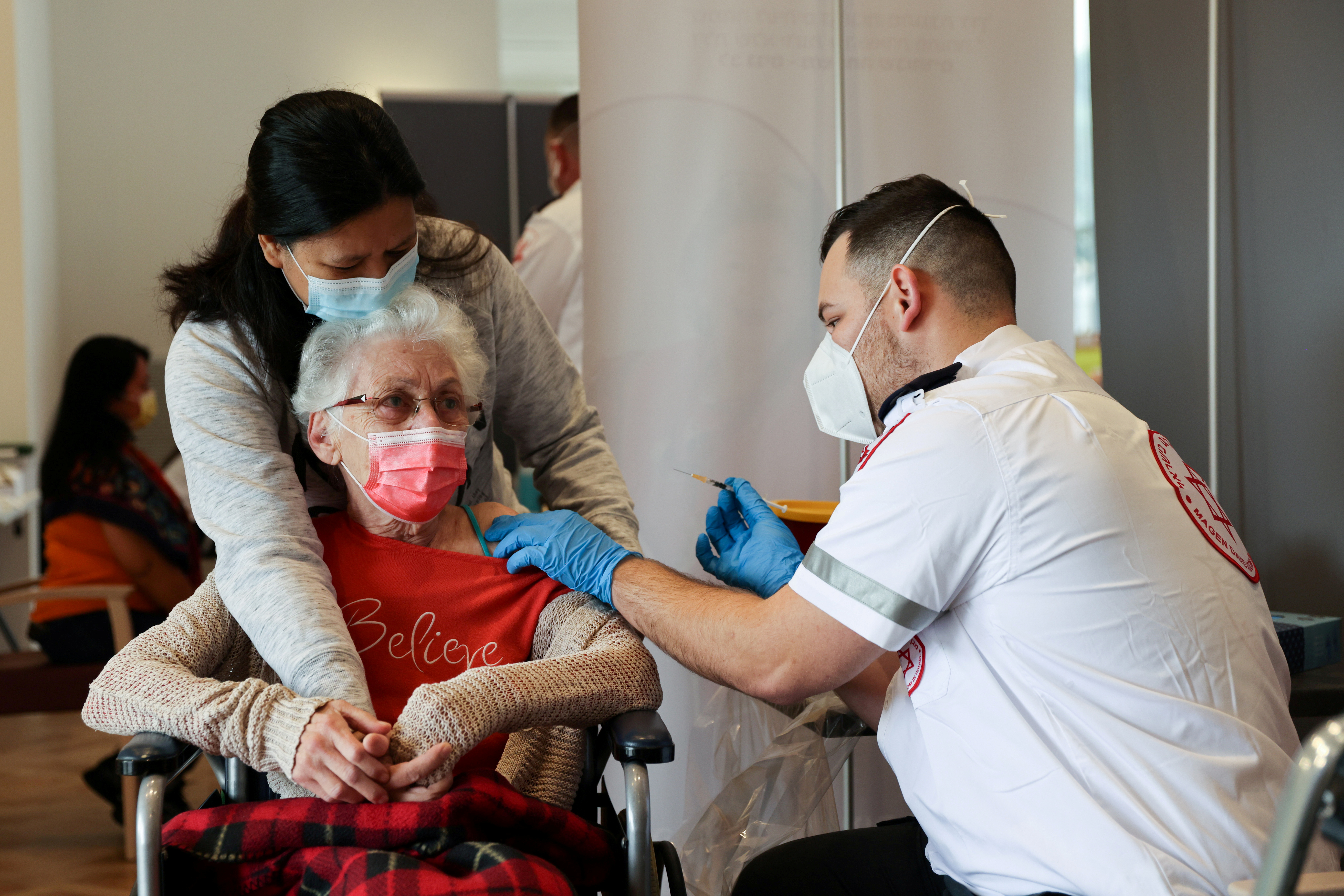 A elderly woman receives a booster shot of her vaccination against the coronavirus disease (COVID-19) at an assisted living facility, in Netanya, Israel January 19, 2021. REUTERS/Ronen Zvulun/File Photo
