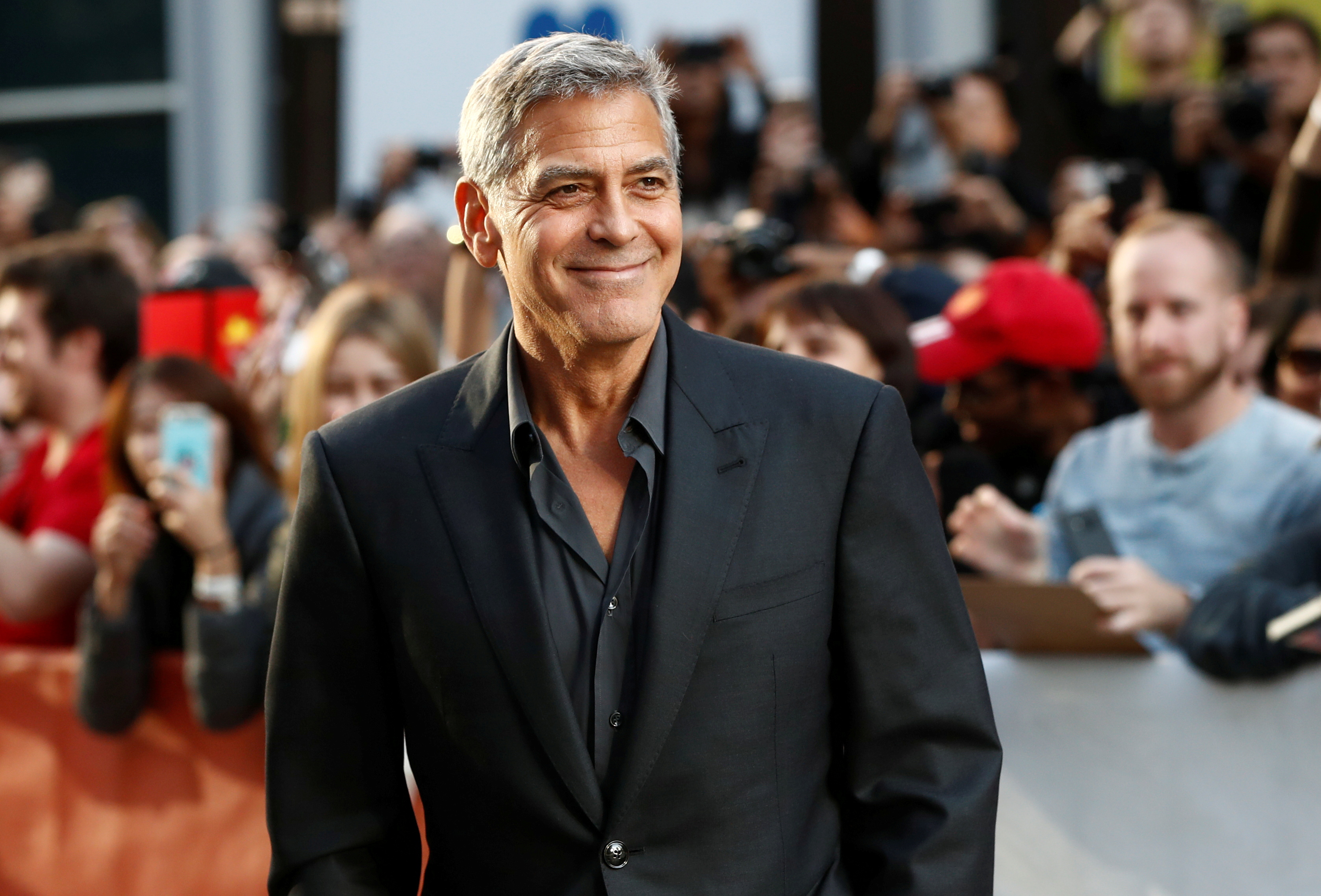 Clooney arrives on the red carpet for the film 