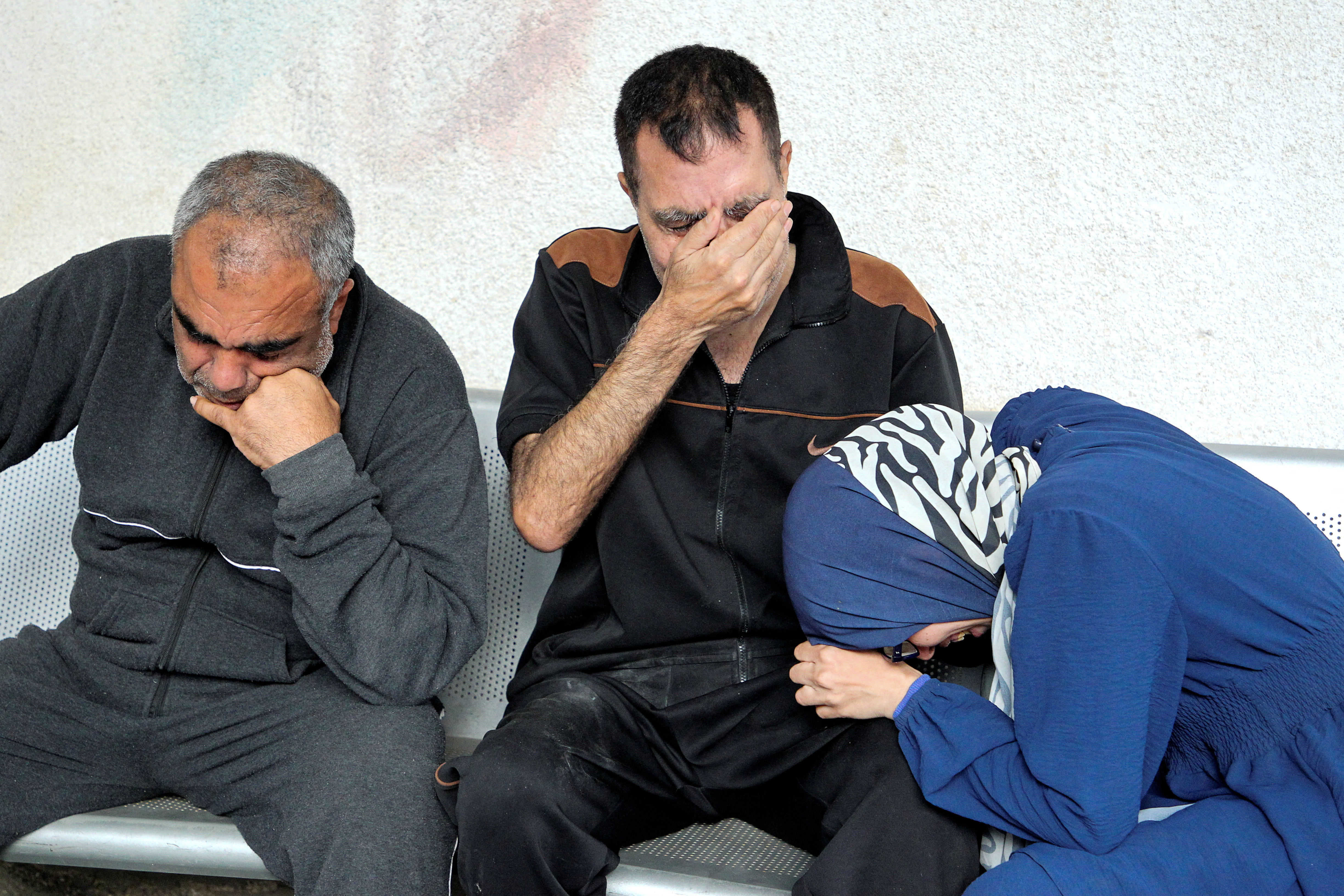 Mourners react next to the bodies of Palestinians killed in an Israeli strike, at Abu Yousef al-Najjar hospital in Rafah