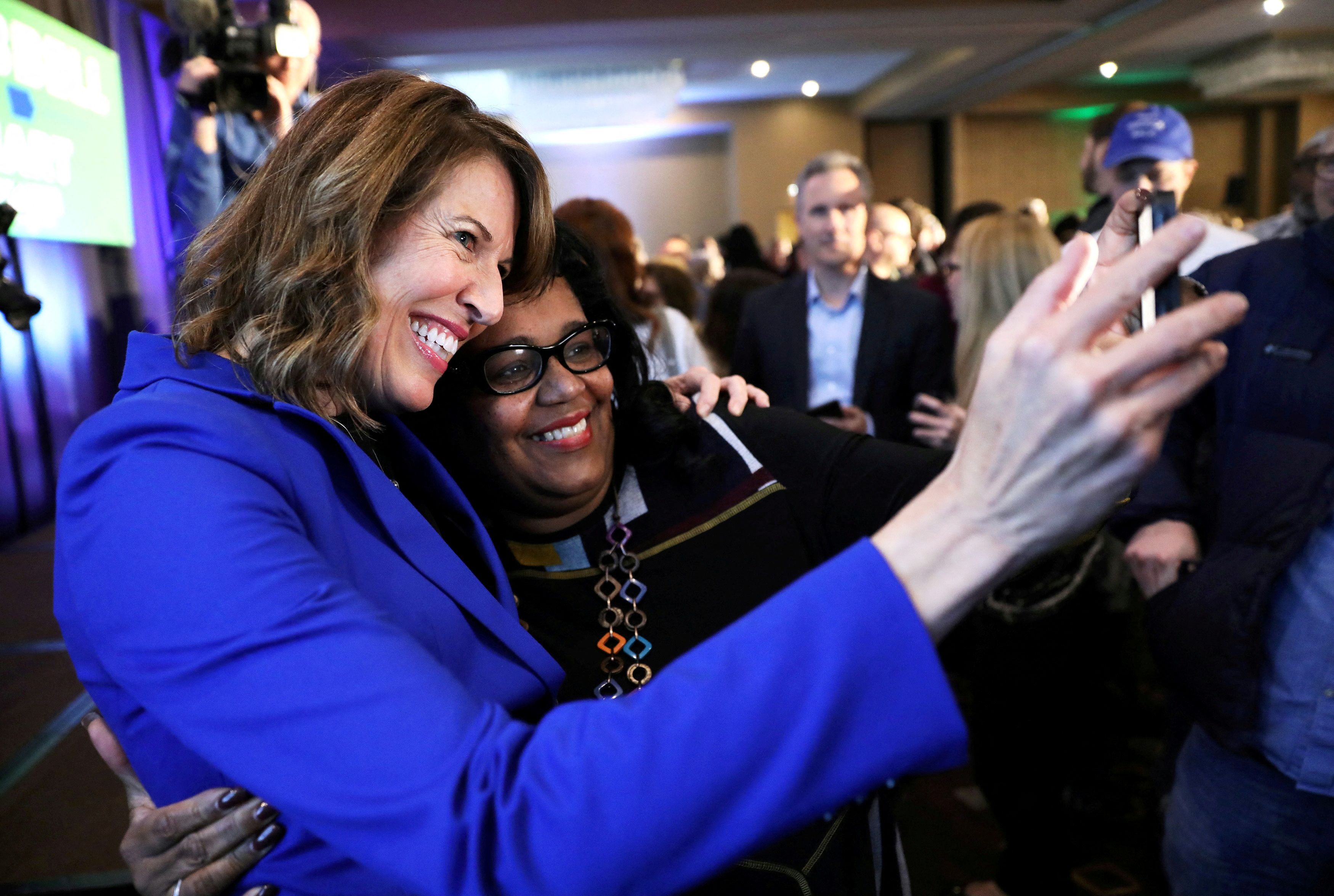 Democratic congressional candidate Cindy Axne (left) takes a photo with West Des Moines City Councilwoman Renee Hardman while appearing at her midterm election night party in Des Moines, Iowa