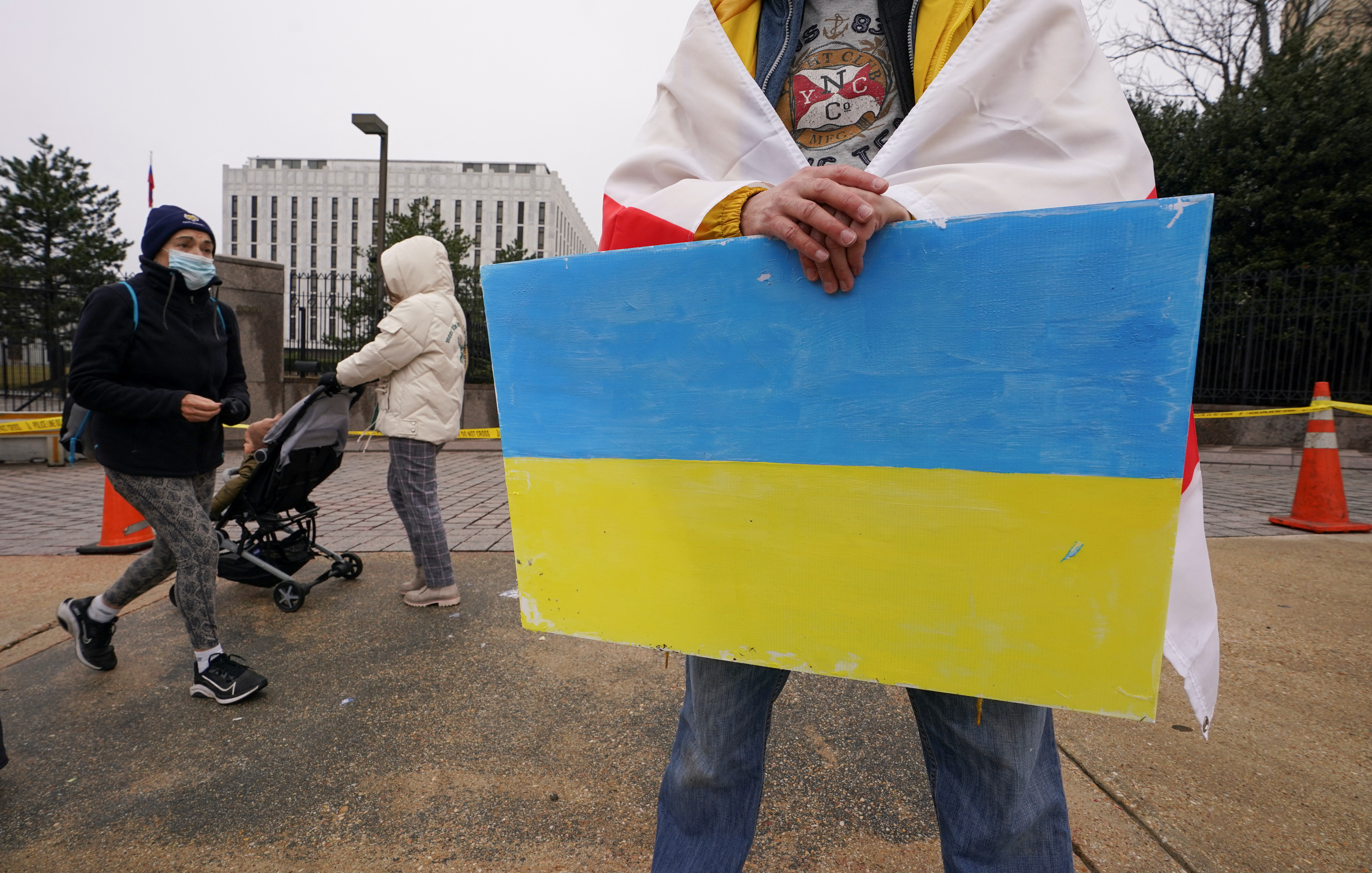 A man holds a Ukraine flag to protest against Russia's invasion of Ukraine in front of the Russian Embassy in Washington, U.S., February 25, 2022 REUTERS/Kevin Lamarque