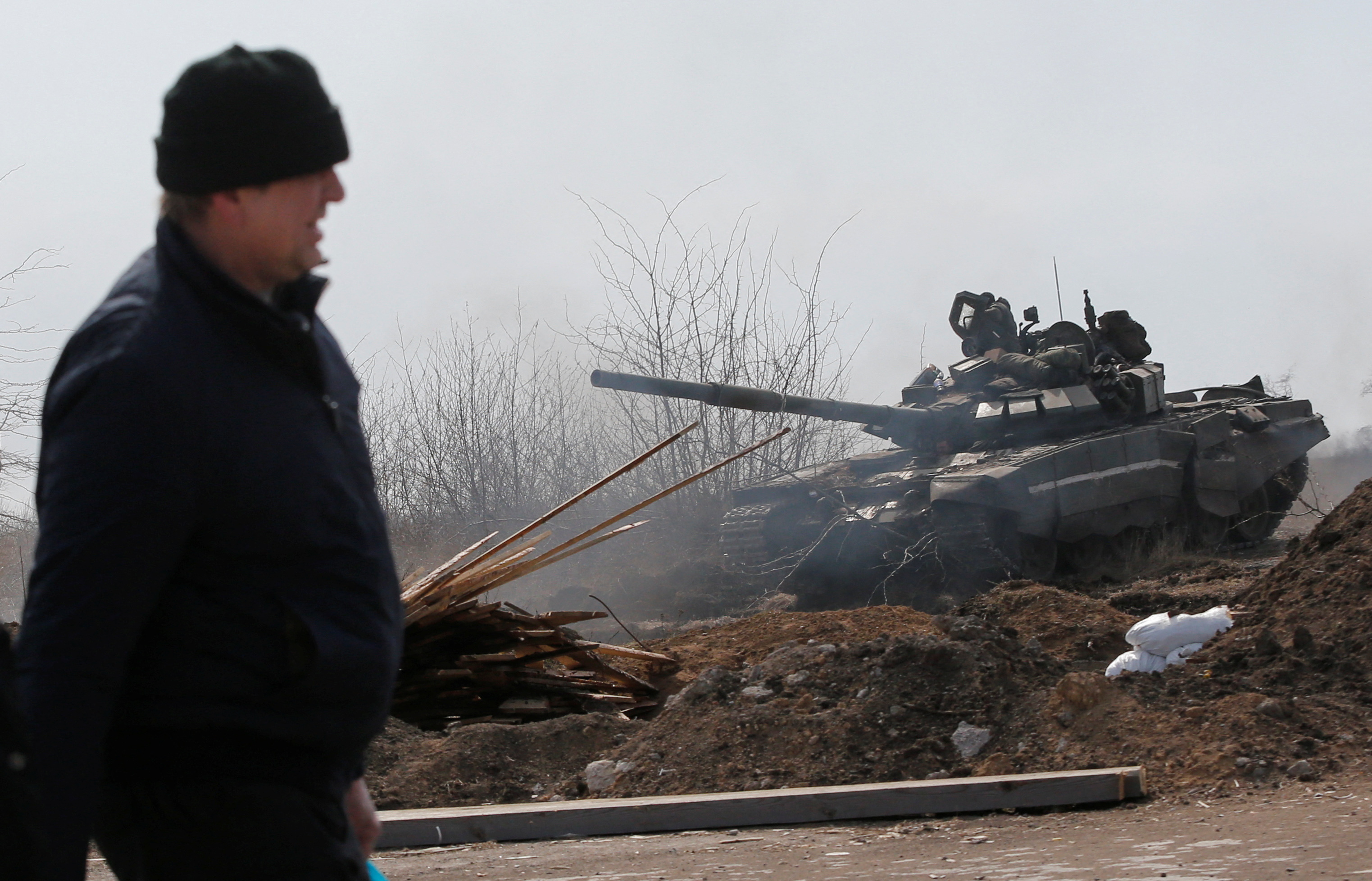 Service members of pro-Russian troops are seen on the outskirts of the besieged city of Mariupol