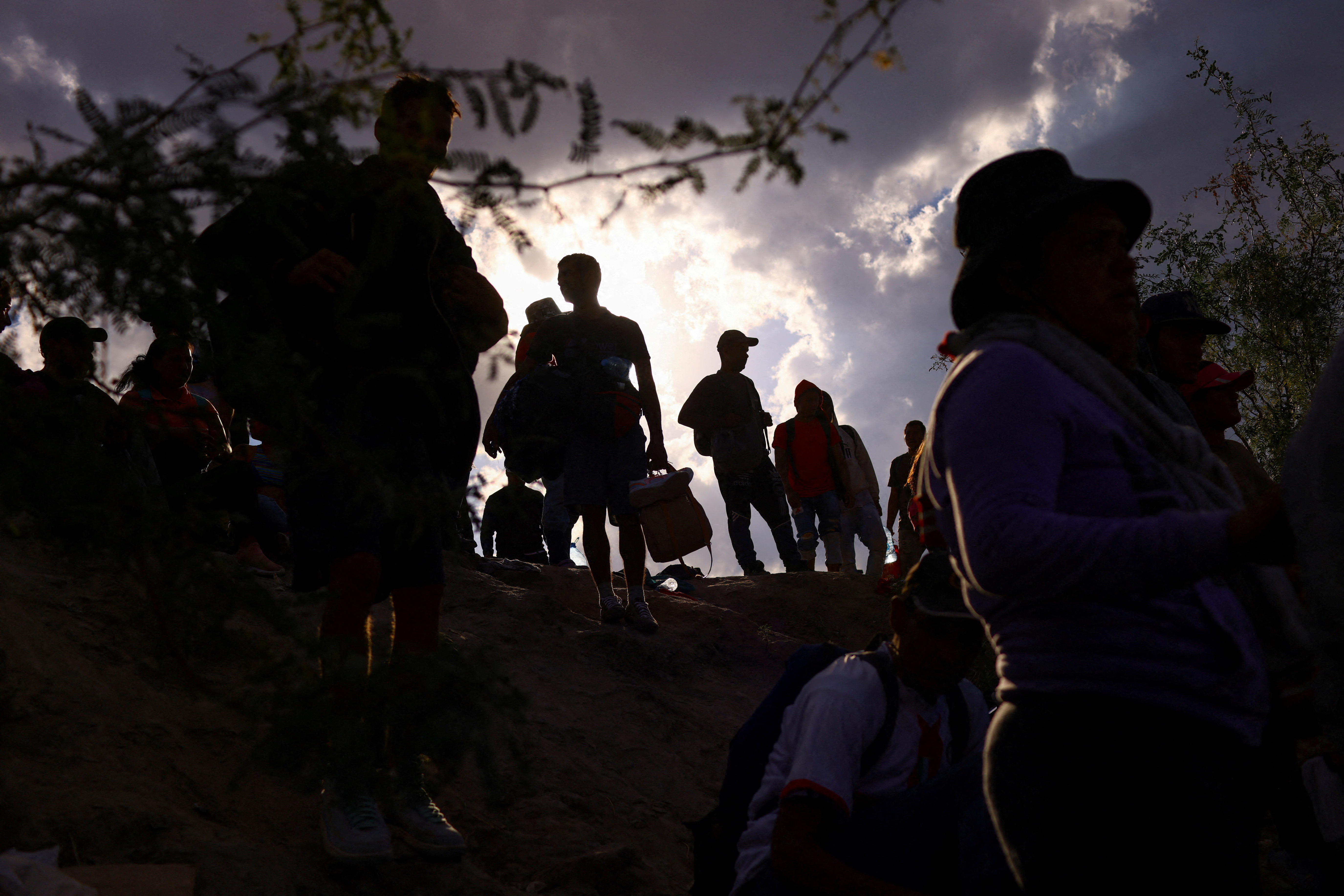 Migrants cross the Rio Bravo River with the intention to request asylum in the United States, as seen from Ciudad Juarez, Mexico