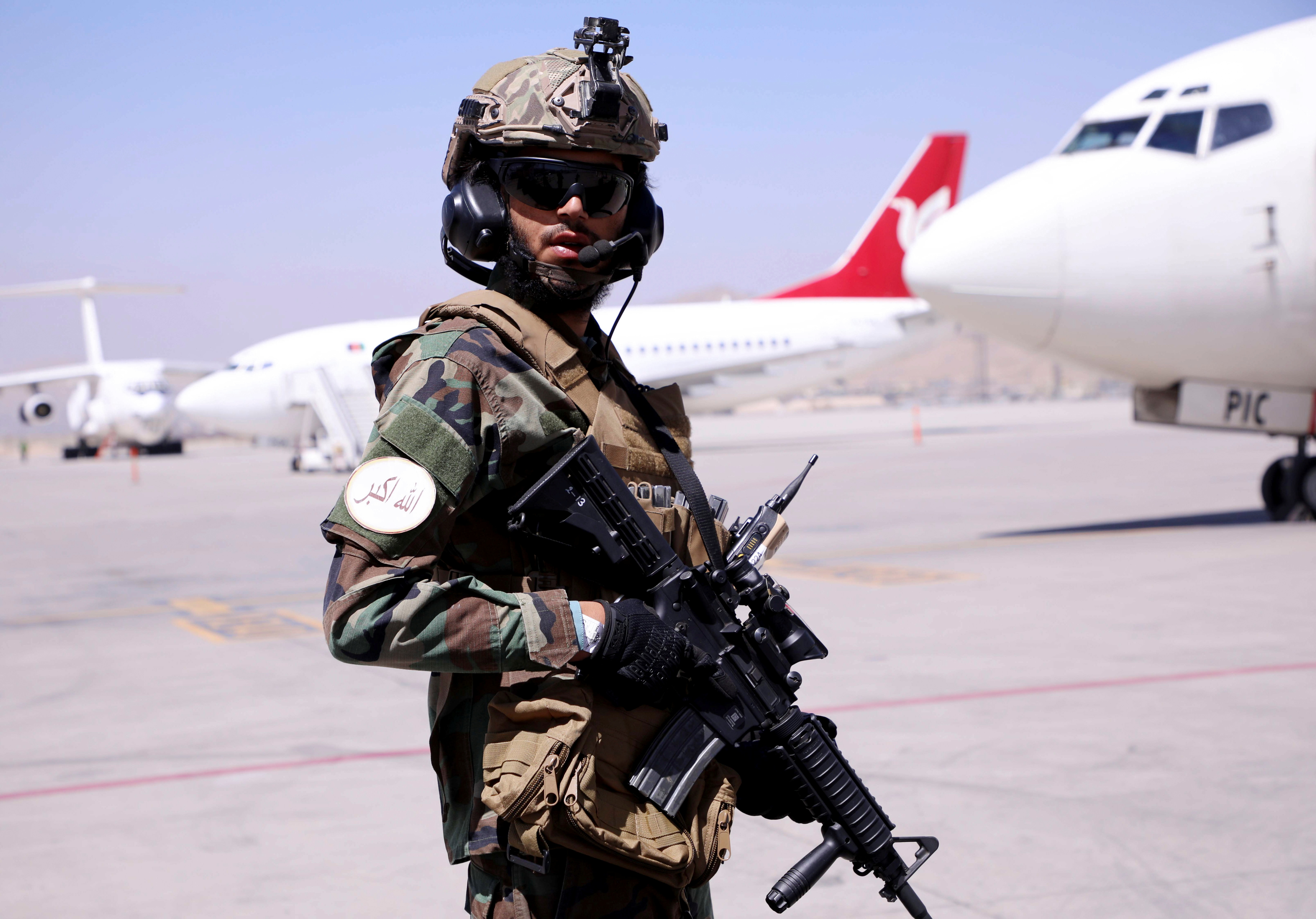 Member of Taliban forces stands guard at Hamid Karzai International Airport in Kabul