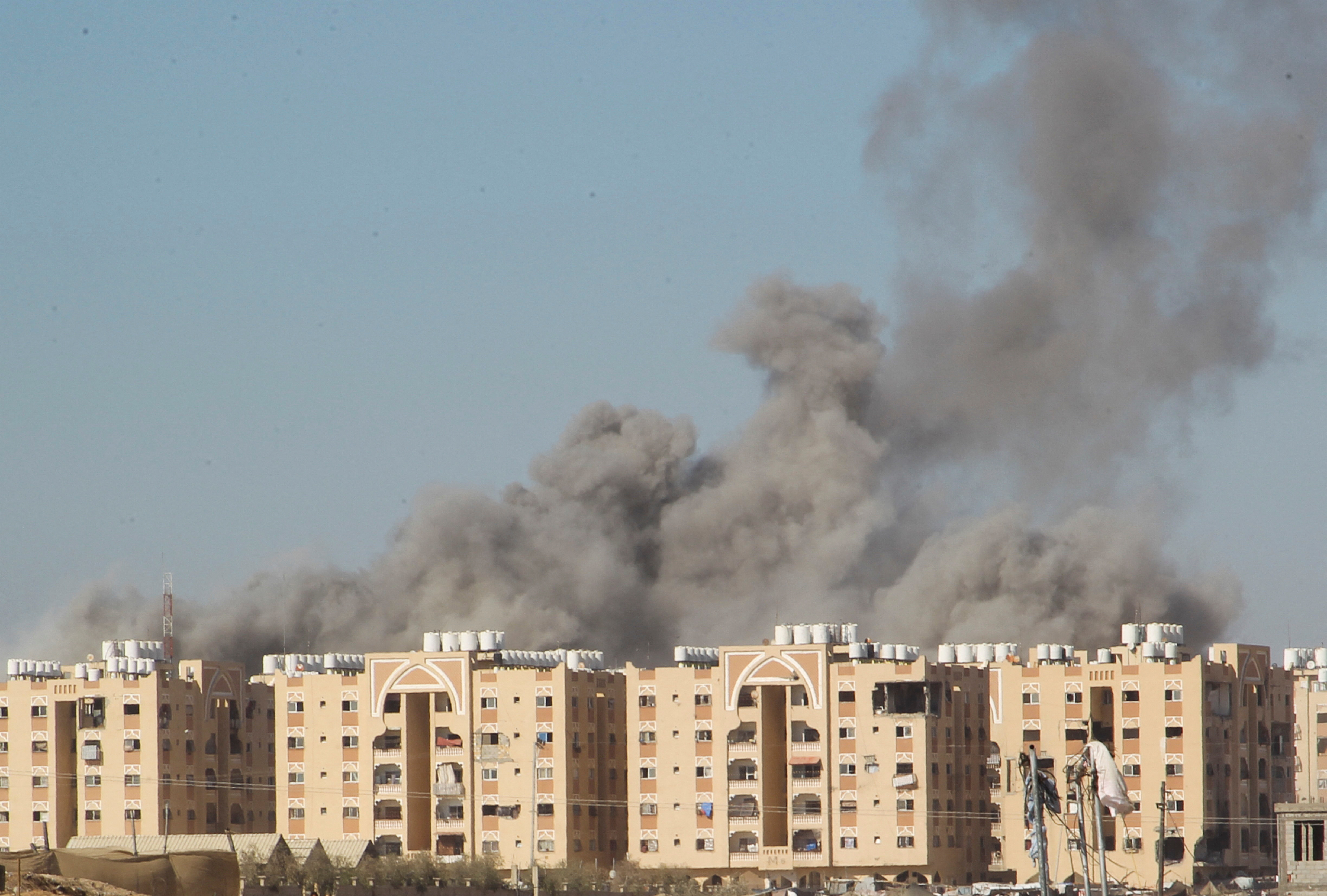 Smoke rises following an Israeli strike on a residential building, in Khan Younis