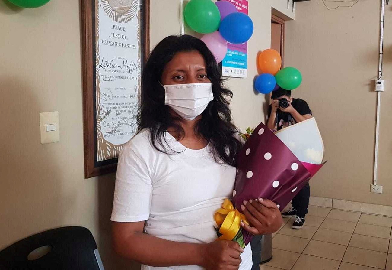 Woman poses for picture after being released from jail in San Salvador