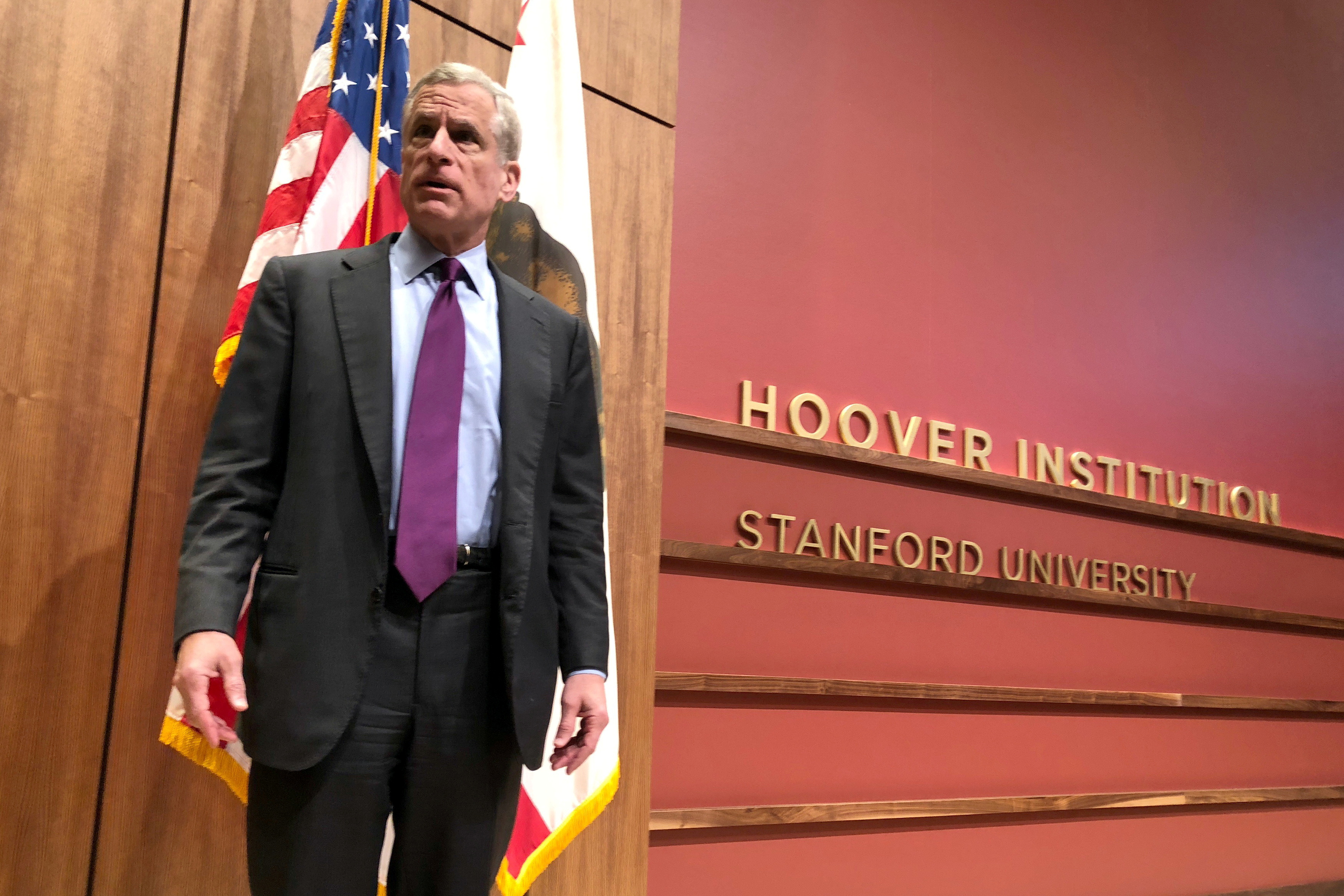 Dallas Federal Reserve Bank President Kaplan stands on a stage in Stanford