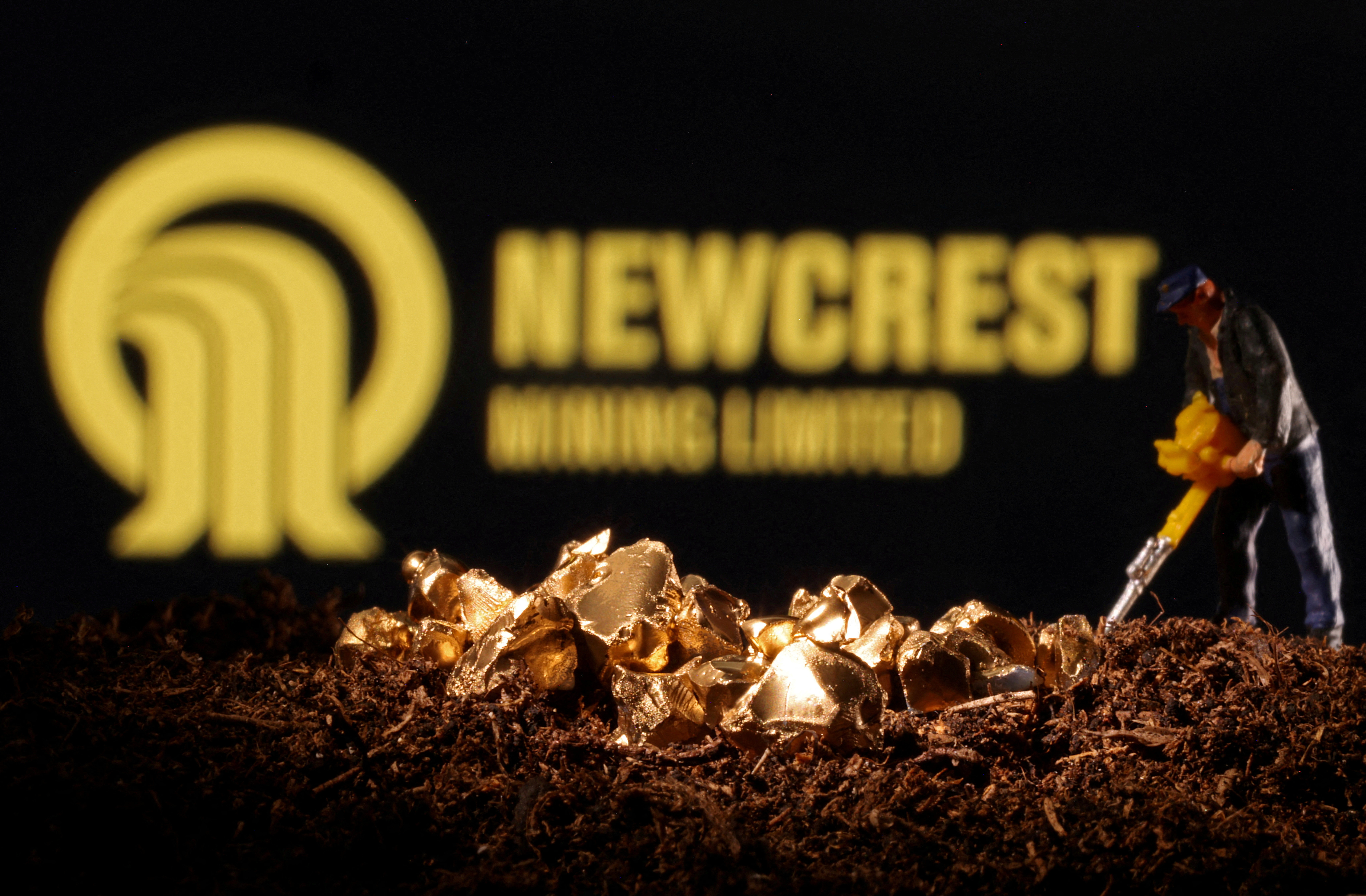 Small toy figure and imitation gold are seen in front of the Newcrest logo in this illustration
