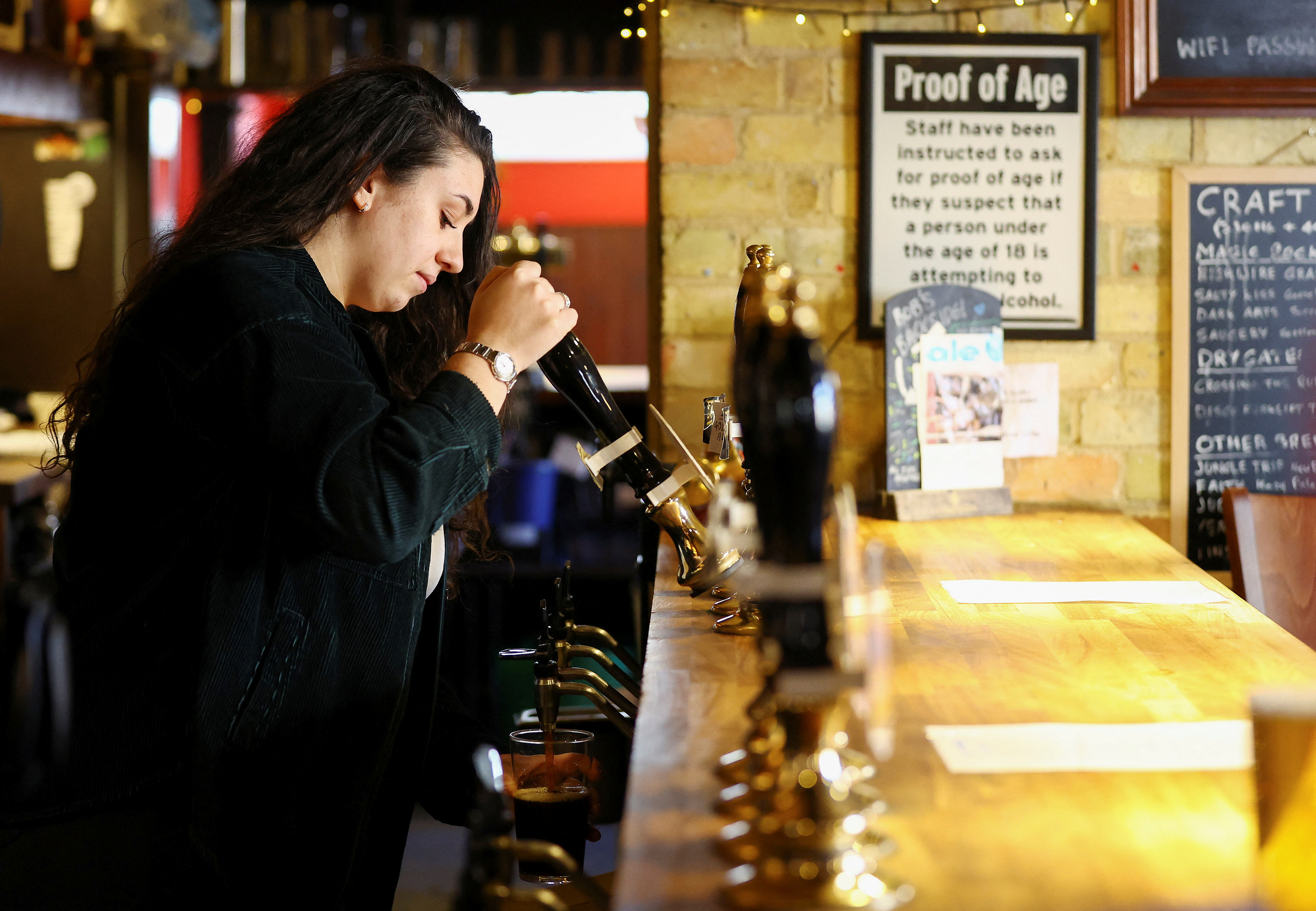 A barmaid pours a pint of Milton Brewery’s Minerva at the Haymakers pub, in Cambridge
