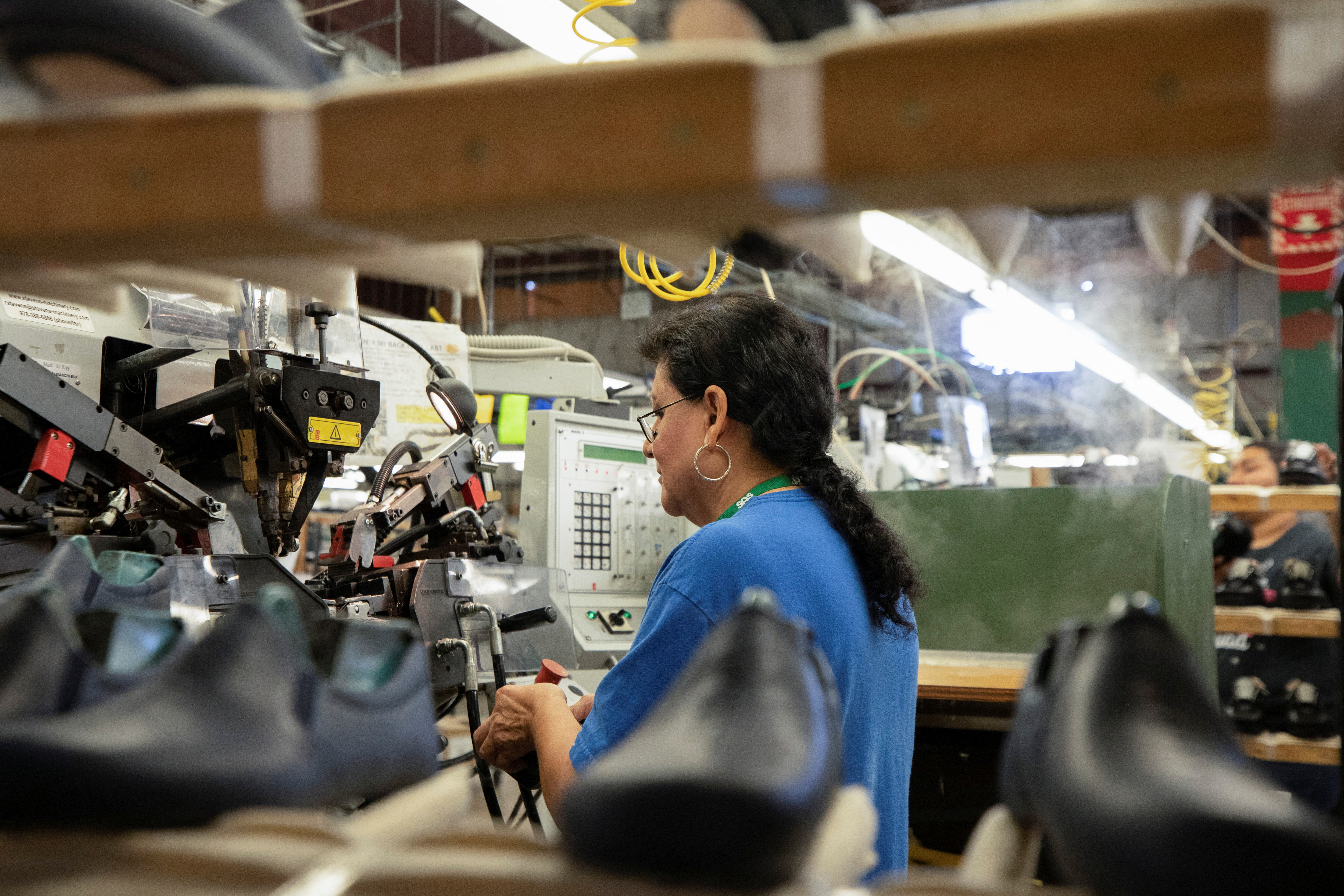 A woman works on the interior mould of a shoe at the San Antonio Shoe Factory in Del Rio