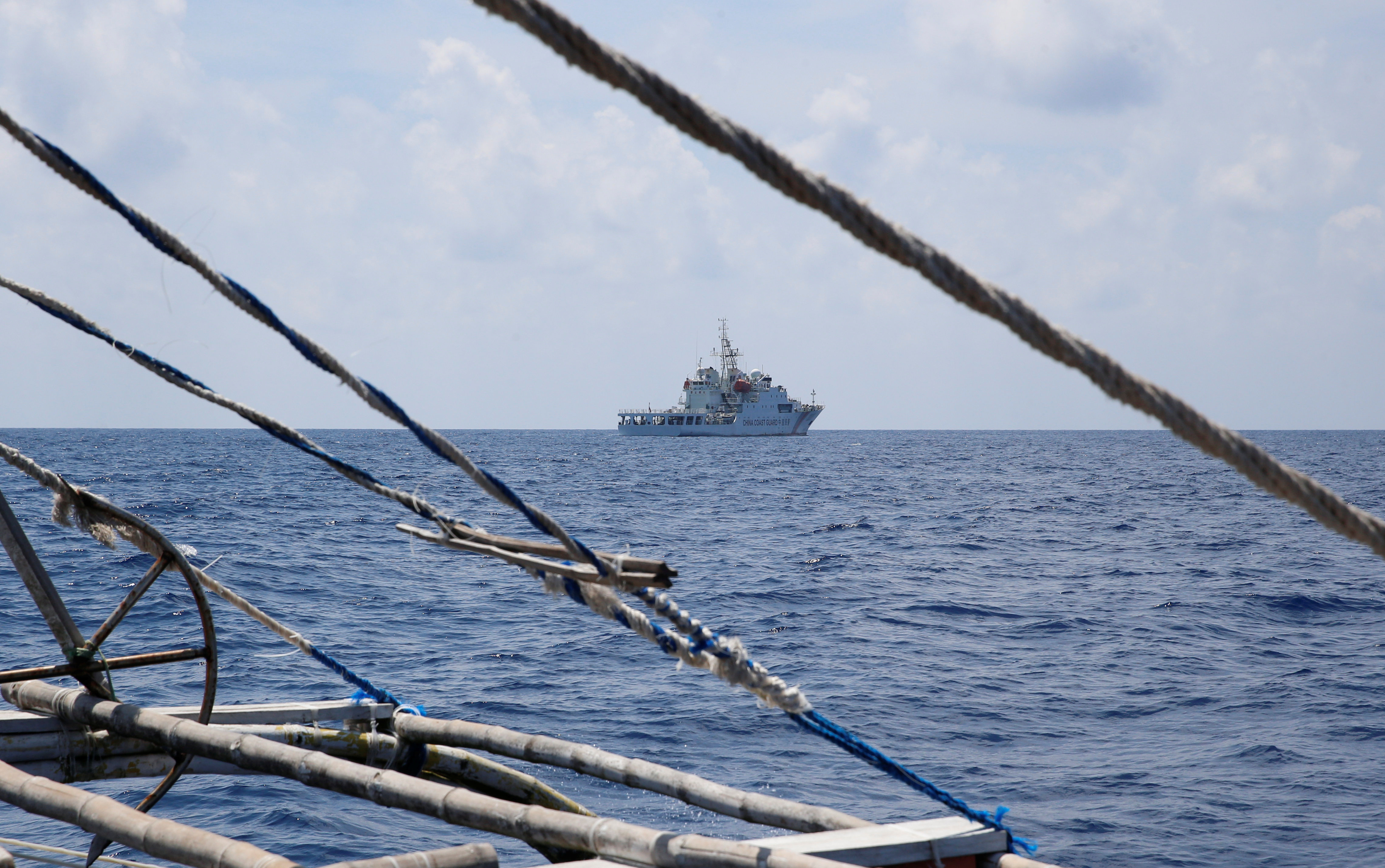 A China Coast Guard ship is seen from a Philippine fishing boat at the disputed Scarborough Shoal