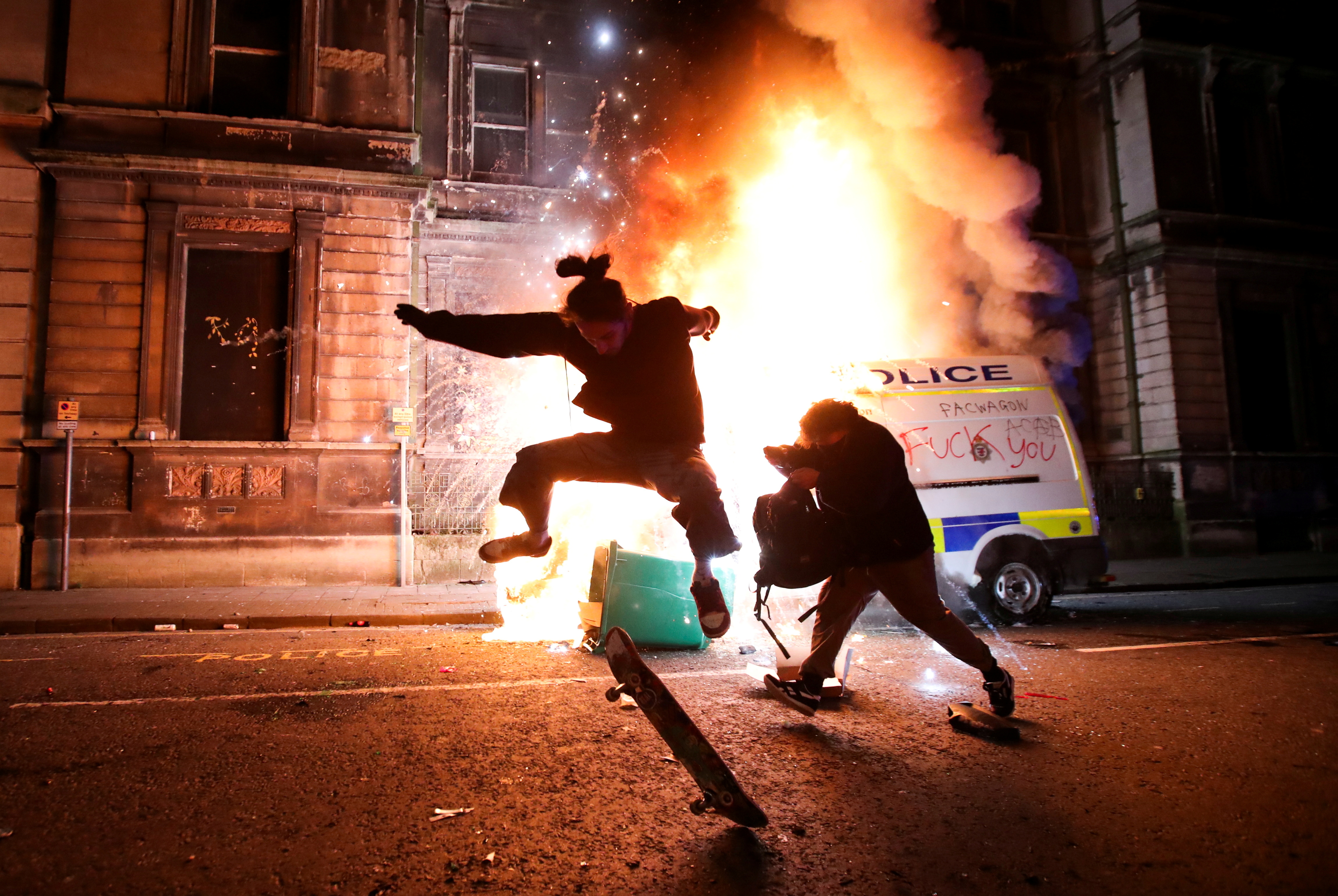 ENGLAND: Police officers hurt, vehicles set on fire in violent protest in Bristol 6 A demonstrator skateboards in front of a burning police vehicle during a protest against a new proposed policing bill, in Bristol, Britain, March 21, 2021. REUTERS/Peter Cziborra