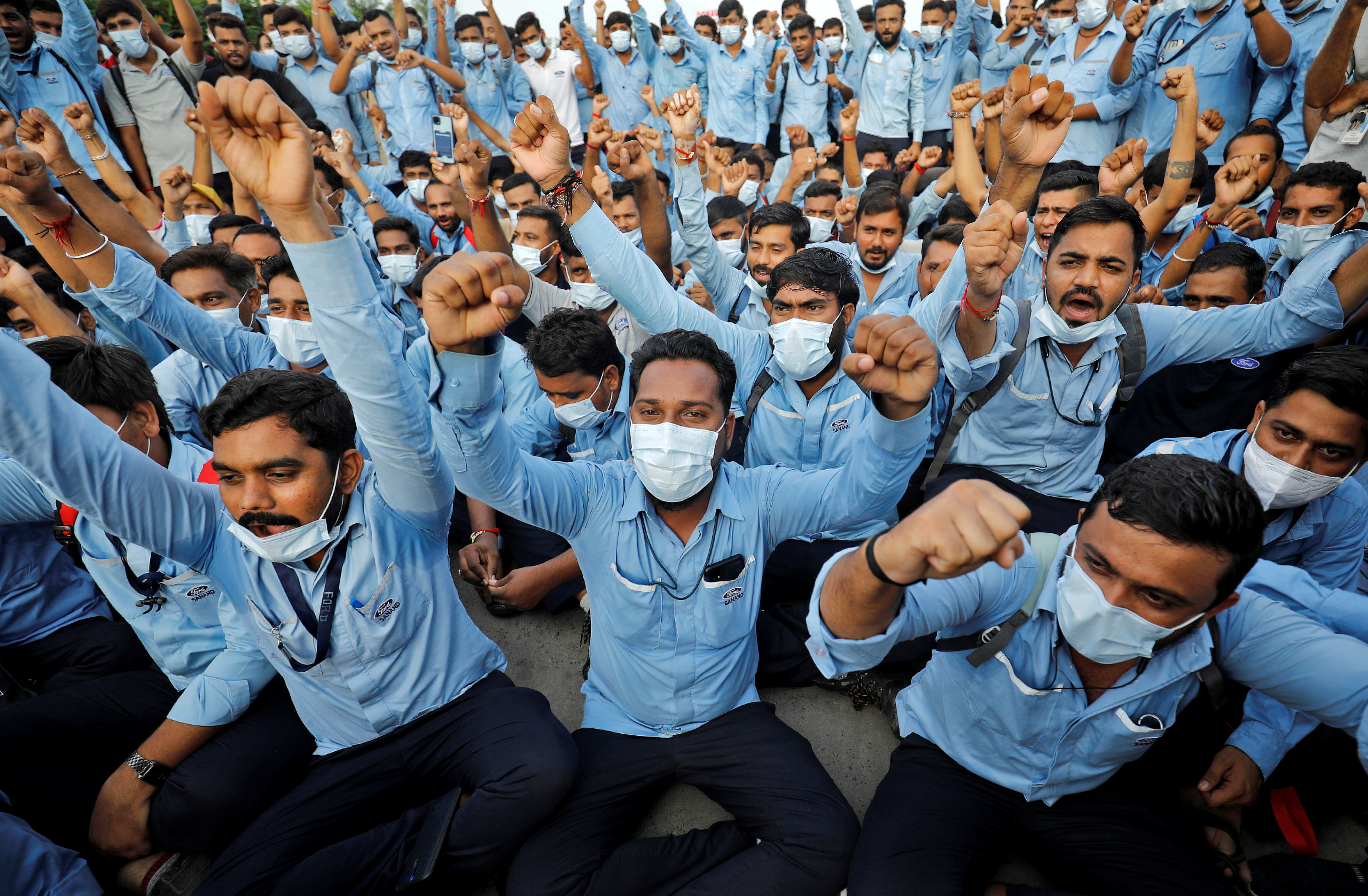Workers of Ford Motor Co. shout slogans during a protest outside Ford's car assembly and engine-making facility in Sanand, Gujarat, India, September 21, 2021. REUTERS/Amit Dave