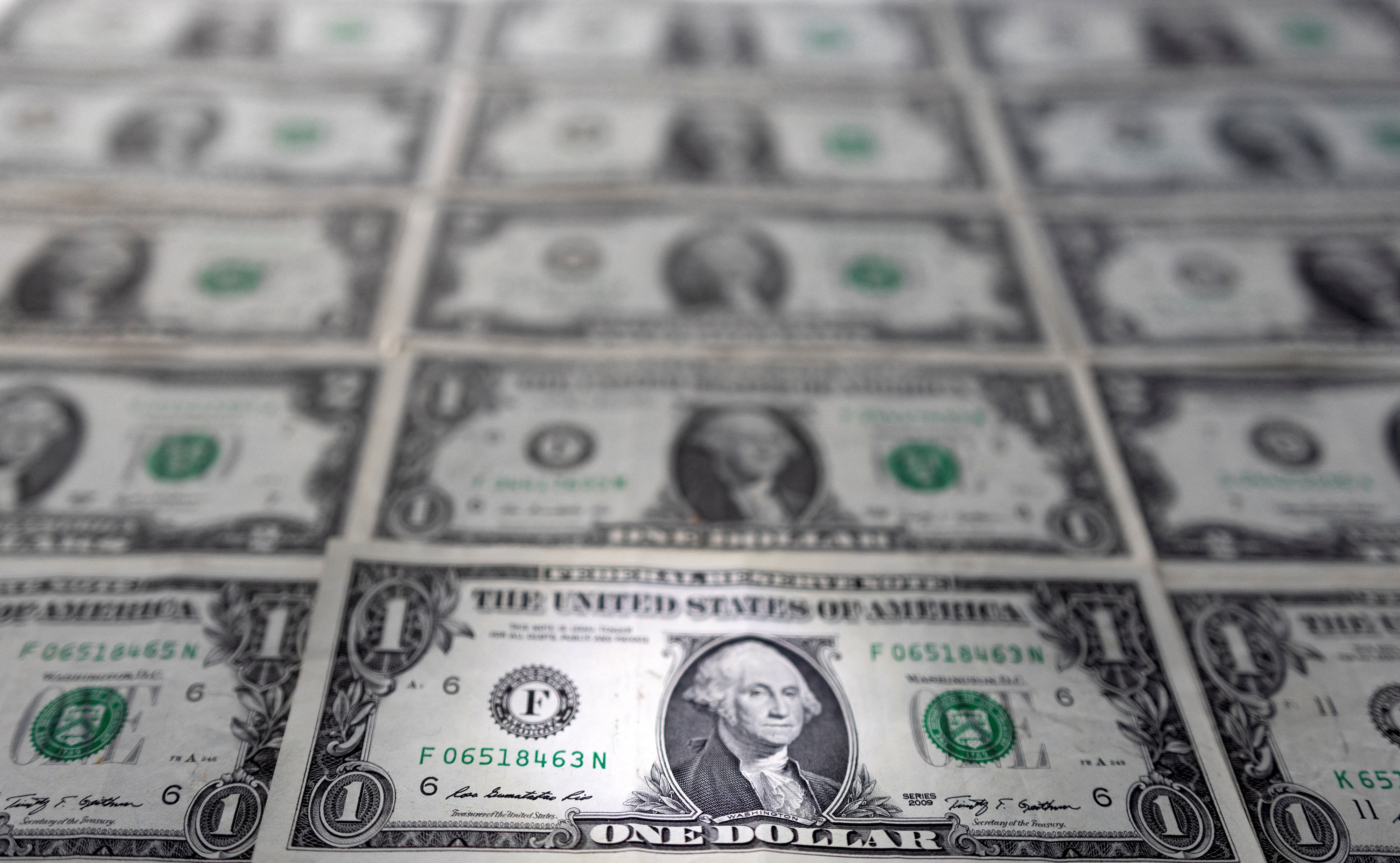 Pile of Various US American Dollar Money Bills Spread on Table