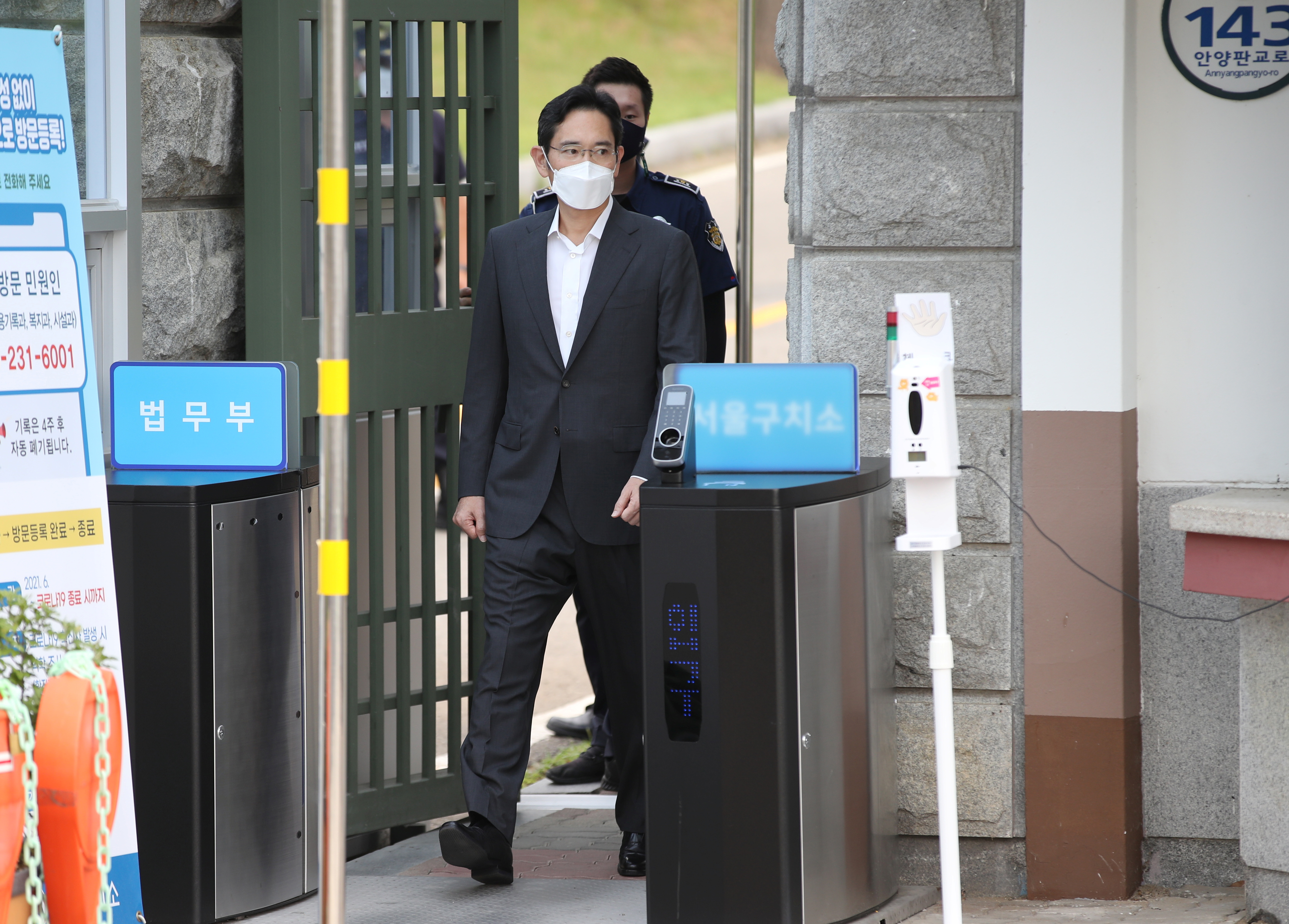 Samsung Electronics vice chairman Jay Y. Lee walks as he is released on parole from Seoul Detention Center in Uiwang, South Korea, August 13, 2021. Yonhap via REUTERS
