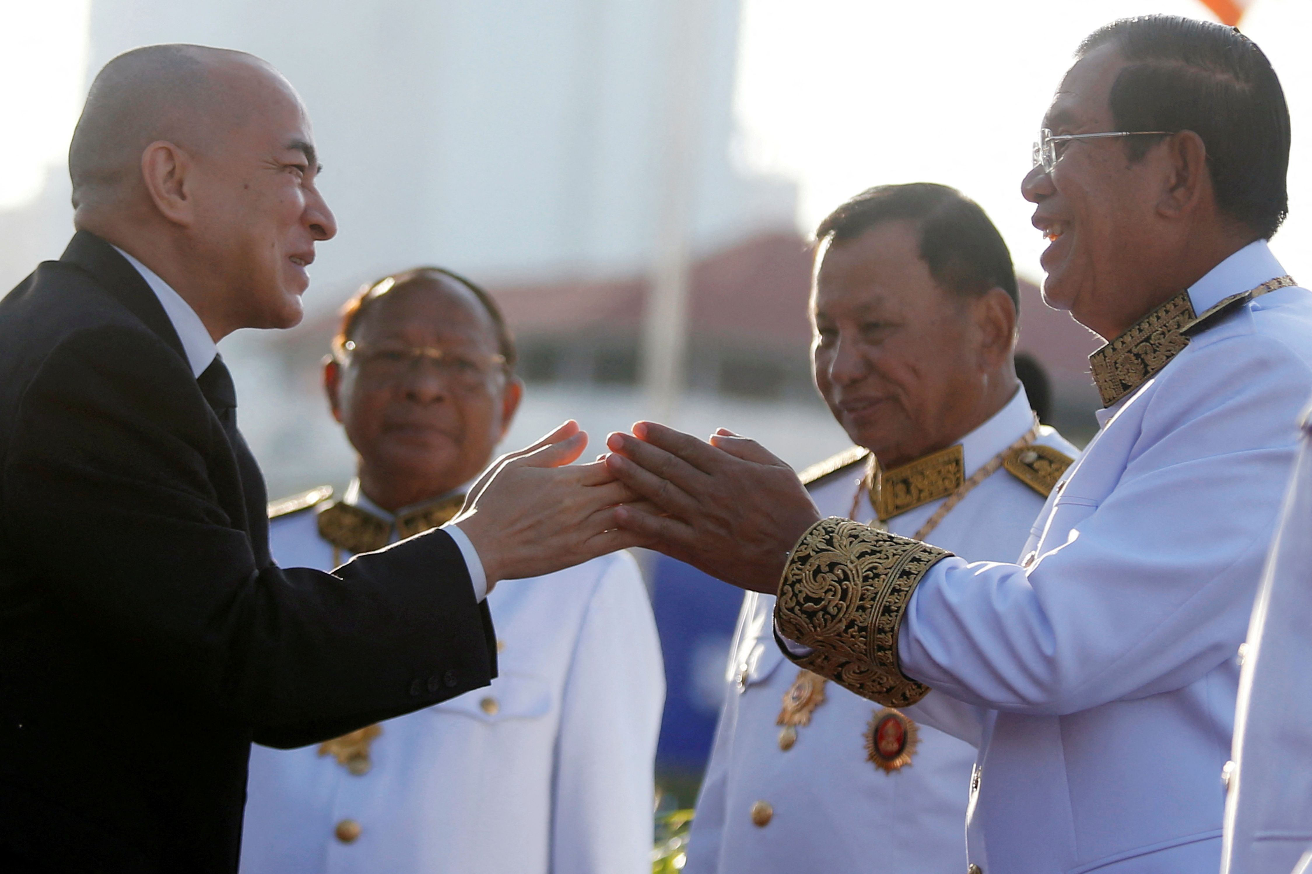 Cambodia's King Norodom Sihamoni greets PM Hun Sen while attending celebrations marking the 65th anniversary of the country's independence in Phnom Penh