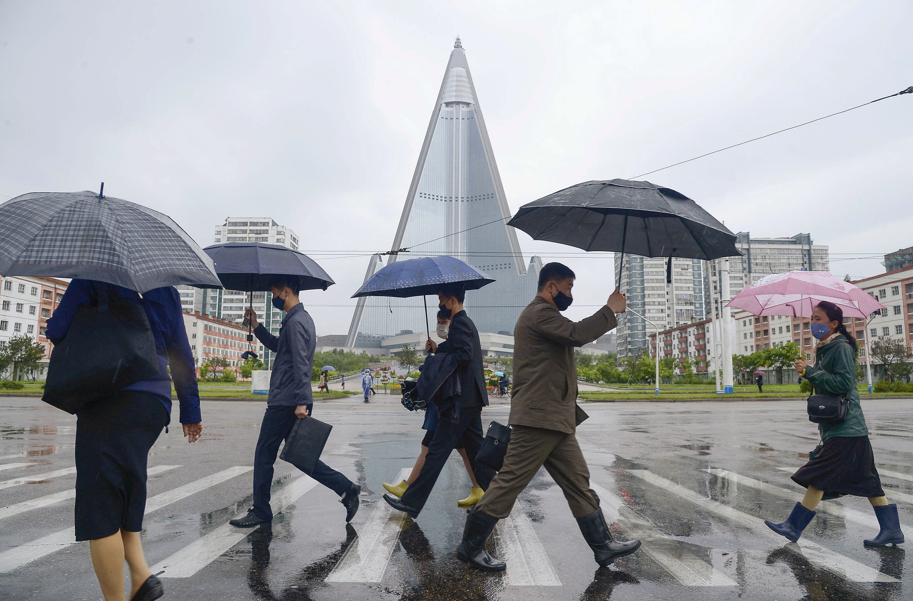 People wearing protective face masks walk amid concerns over the new coronavirus disease (COVID-19) in Pyongyang, North Korea