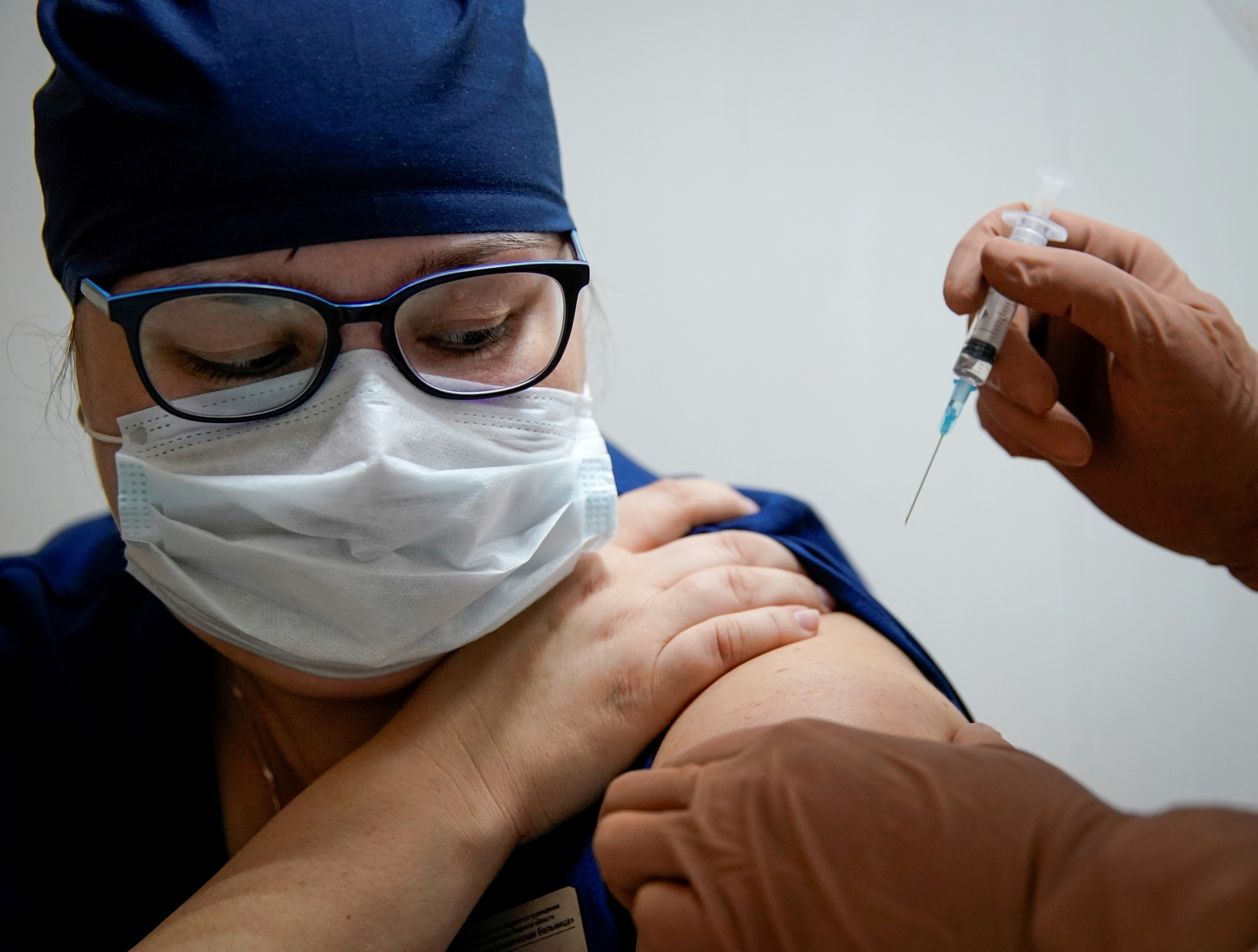 A medic of a regional hospital receives Russia's 'Sputnik-V' vaccine