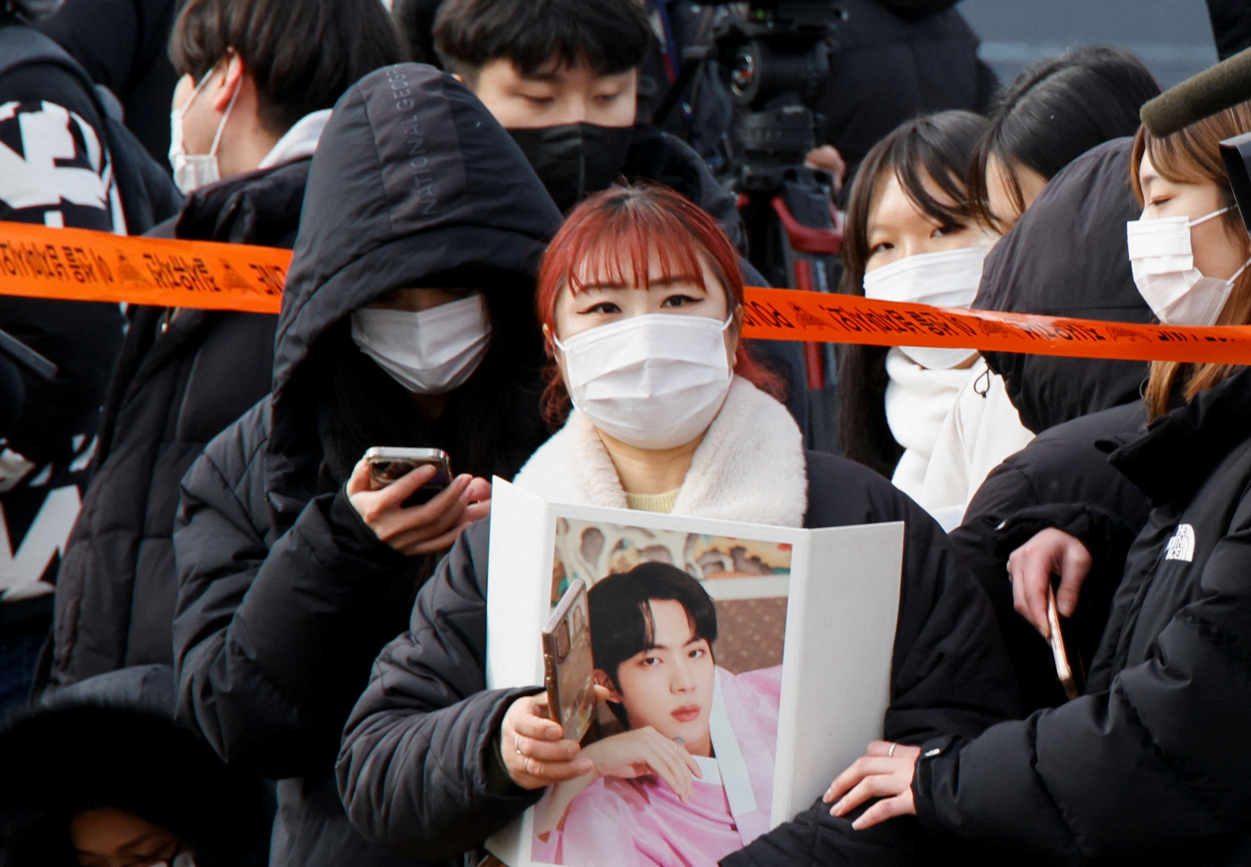 Fans wait outside a South Korean army boot camp where K-pop star and BTS member Jin begins military service, in Yeoncheon