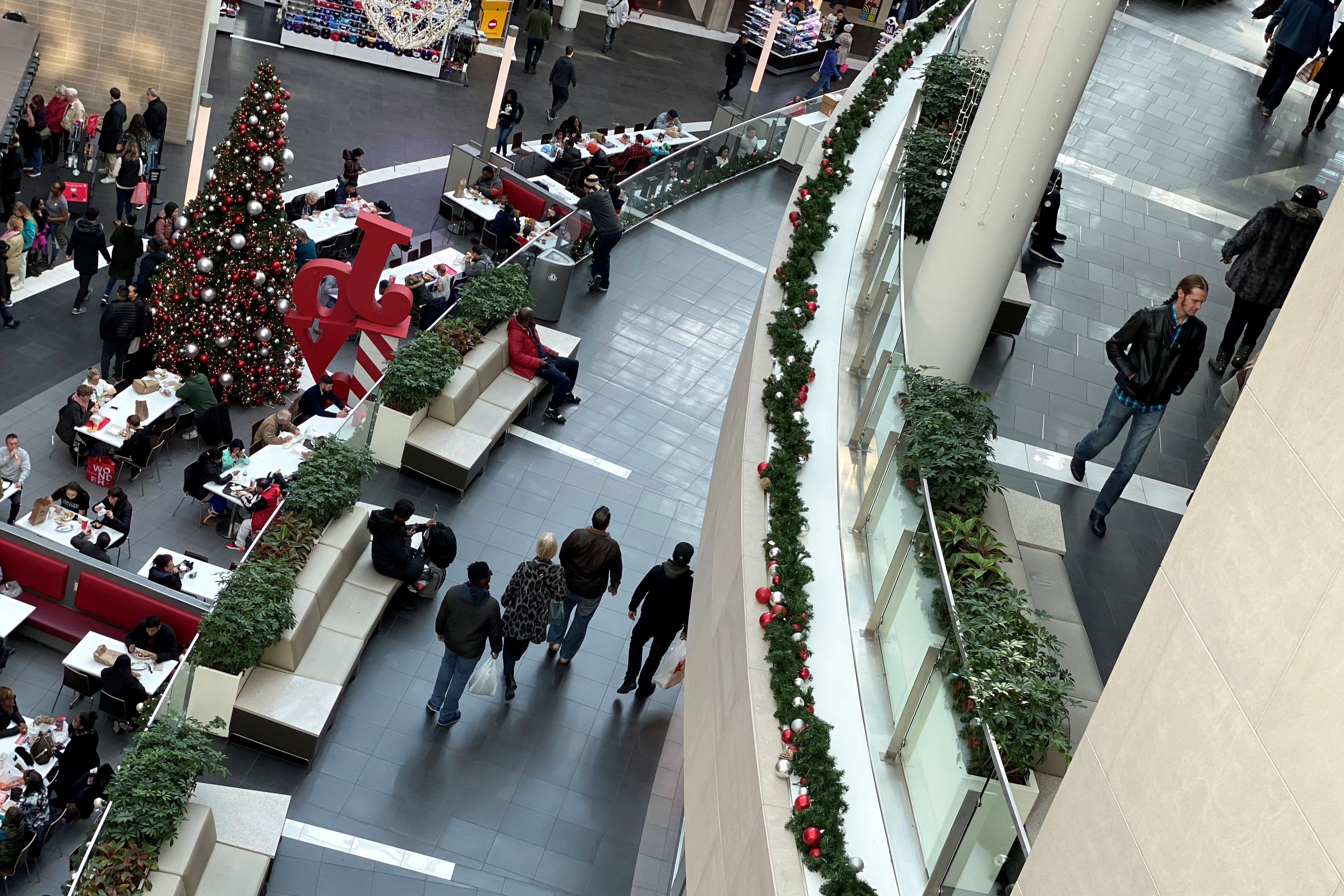 Shoppers make their way through Fashion Centre at Pentagon City, decorated for the holidays, in Arlington, Virginia
