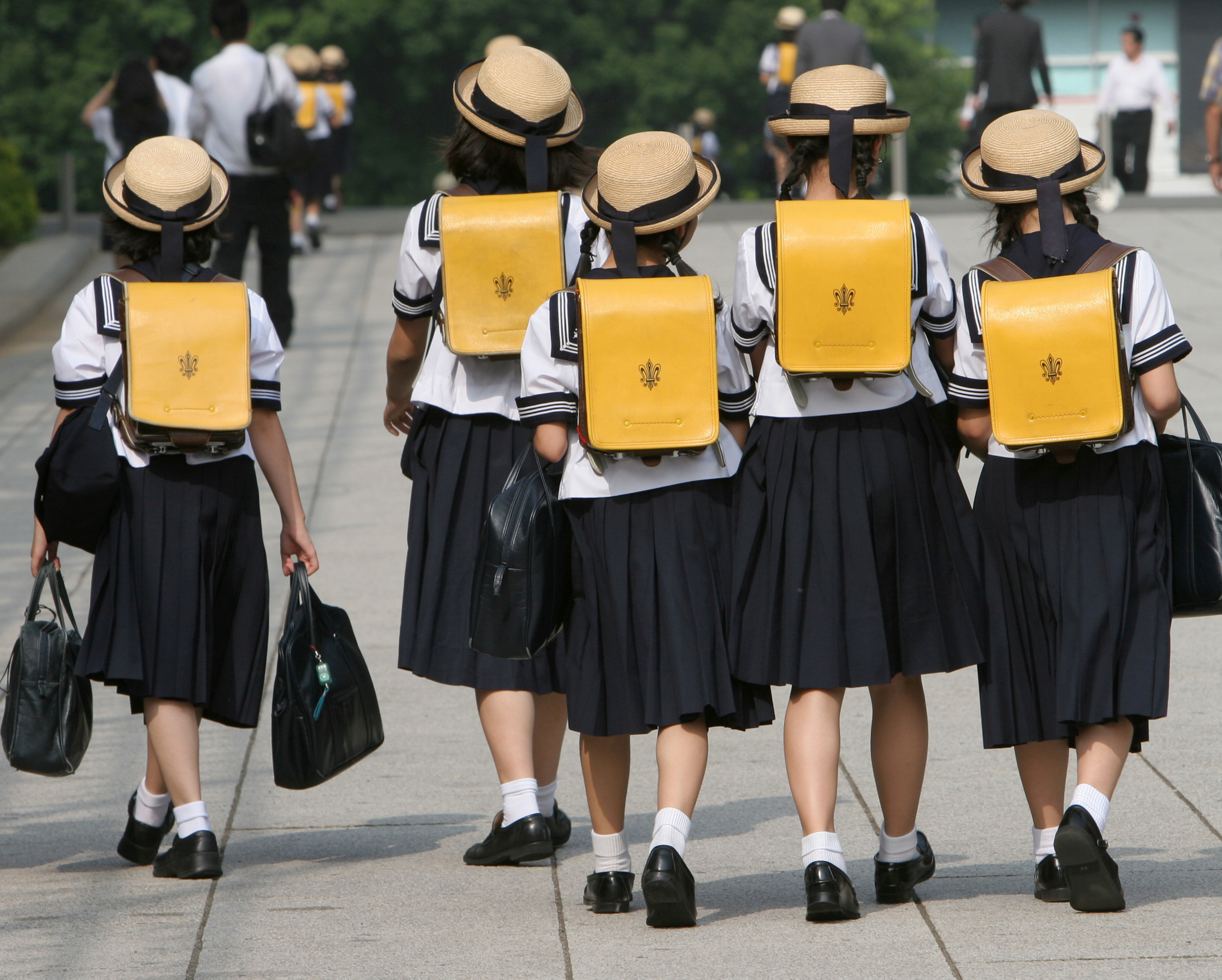 Children walk on way back from school in Tokyo