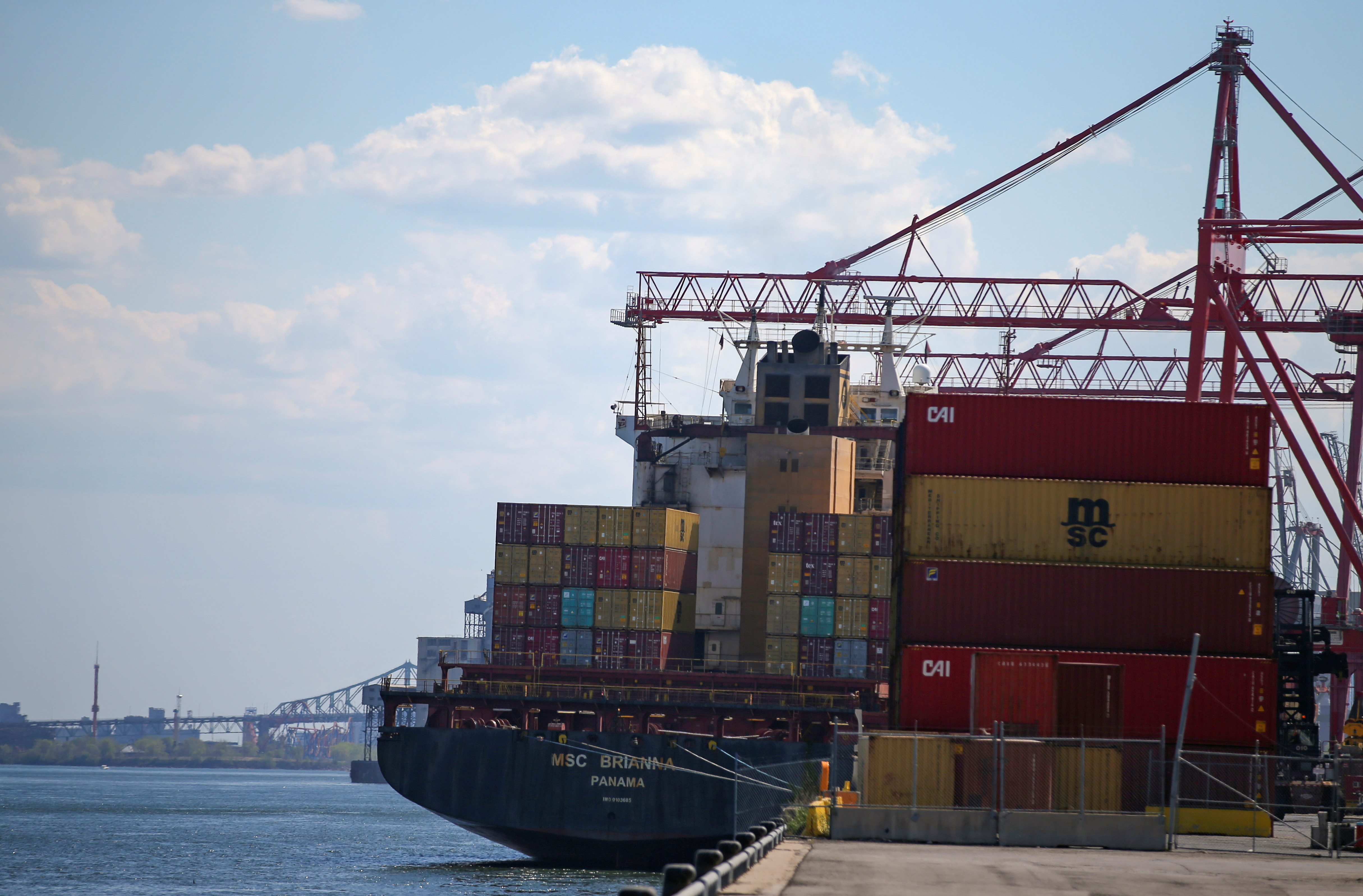 A cargo ship is loaded with shipping containers in the Port of Montreal