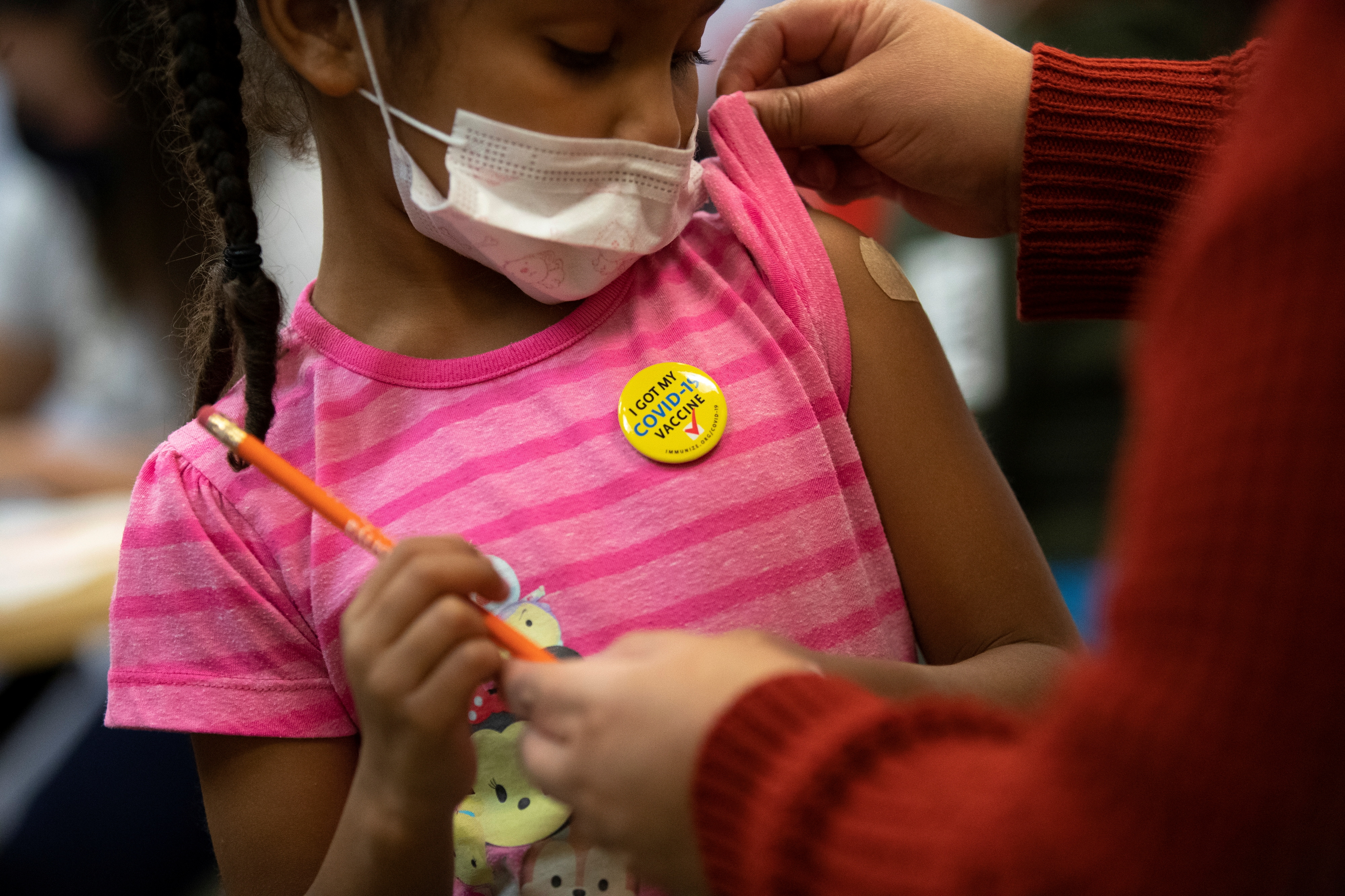 Josclyn Ledisma, 5, examines a band-aid after receiving her first dose of the vaccine against the coronavirus disease (COVID-19) inside Mary's Center in Washington, U.S., November 3, 2021. REUTERS/Tom Brenner