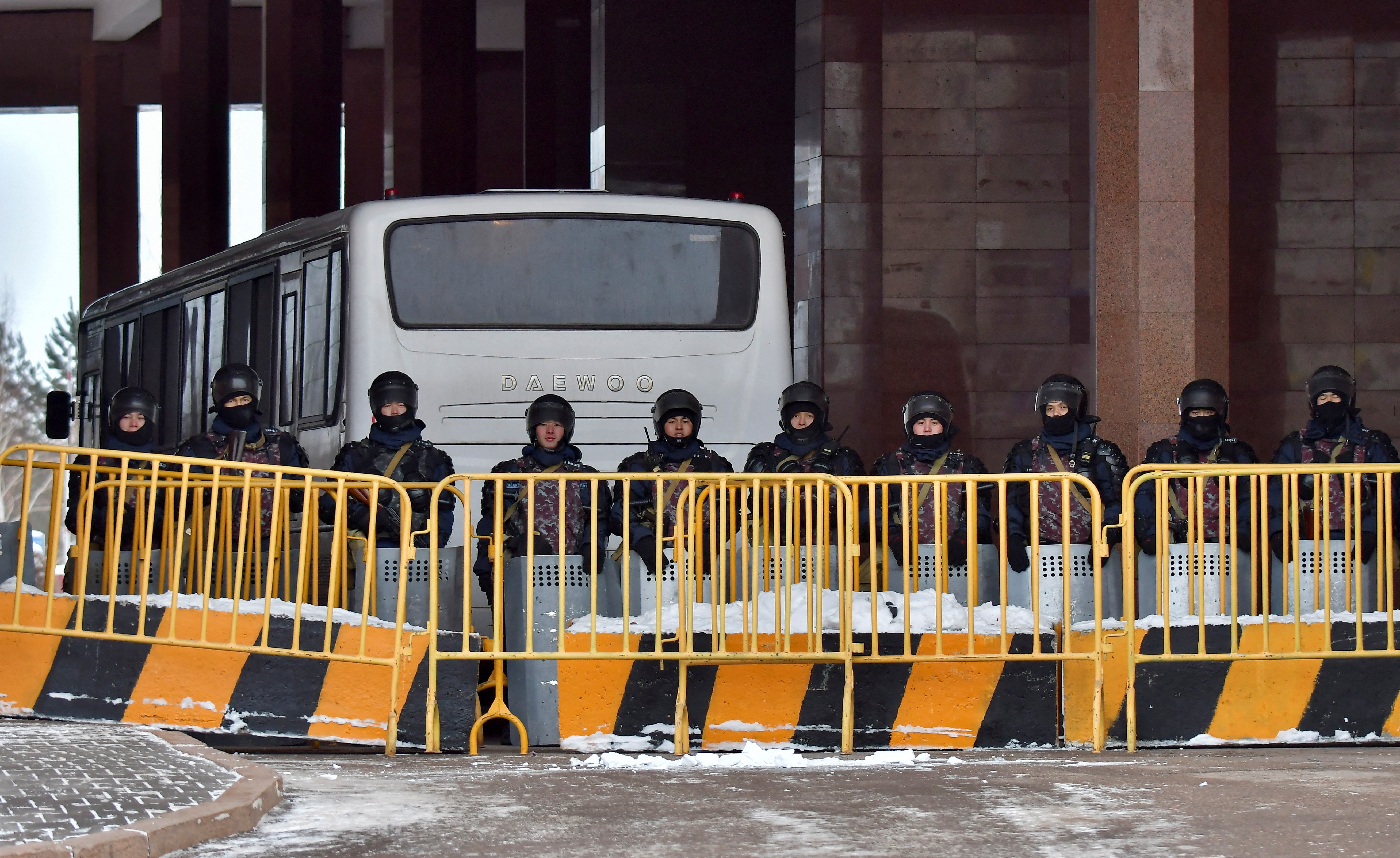 Kazakh law enforcement officers block a street leading to the official presidential residence Akorda after protests against the government, following authorities' decision to lift price caps on liquefied petroleum gas, in Nur-Sultan, Kazakhstan, January 6, 2022. REUTERS/Turar Kazangapov 
