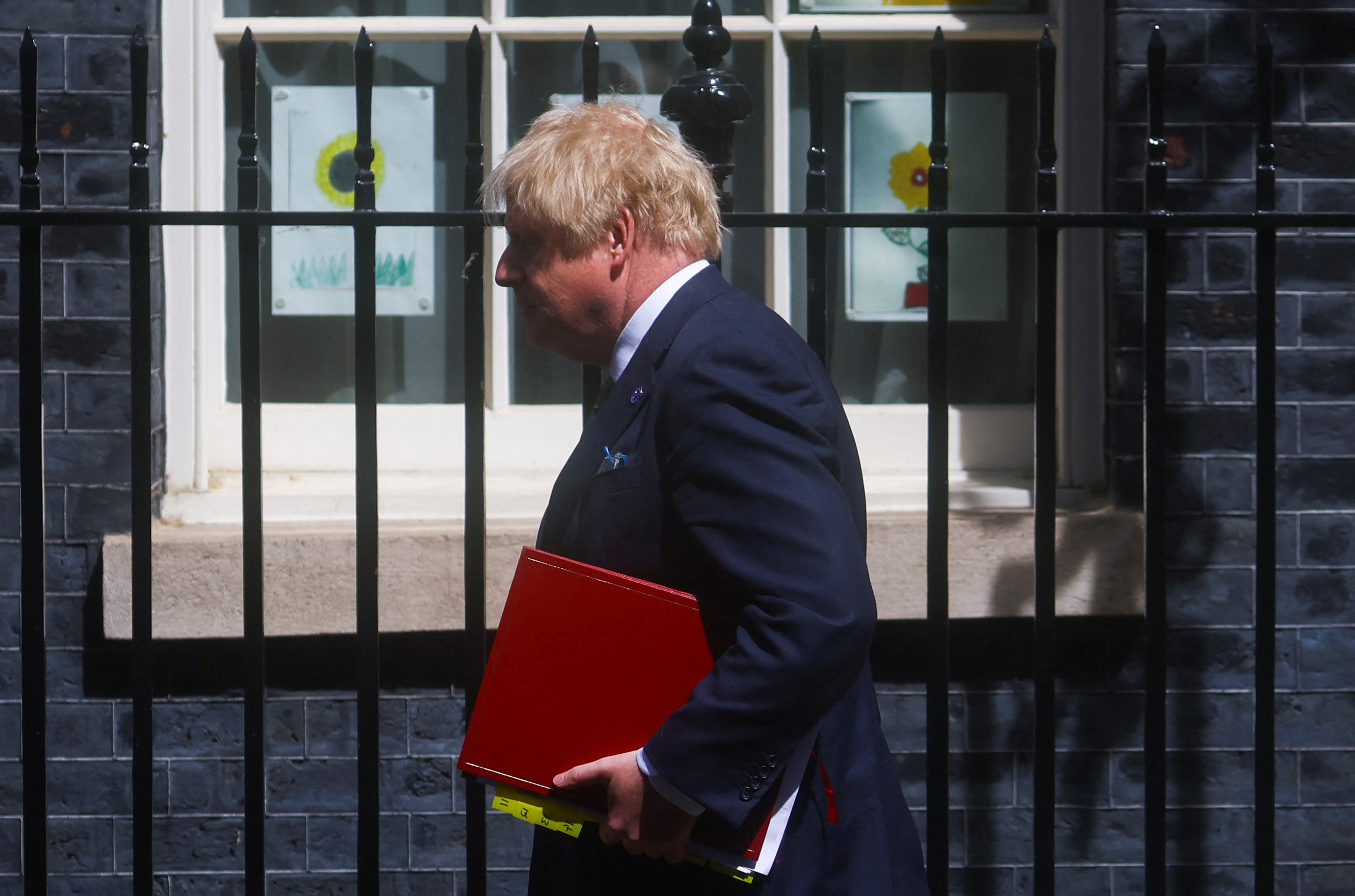 British PM Johnson leaves Downing Street to take questions in parliament, in London