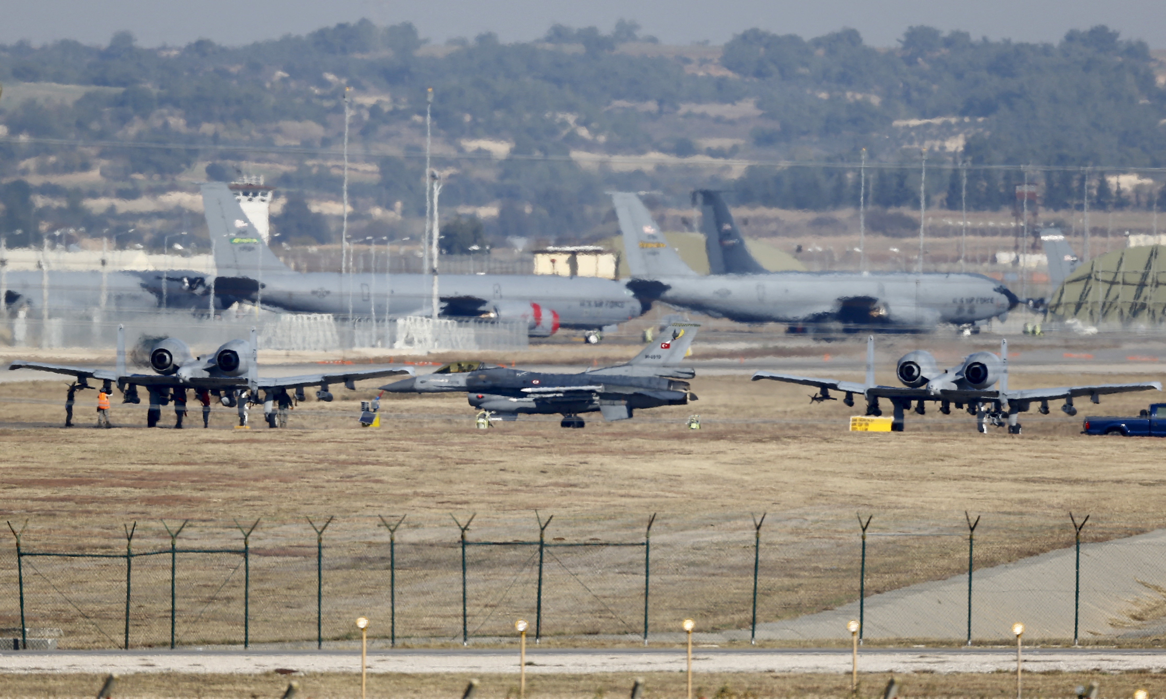A Turkish Air Force F-16 fighter jet is seen between U.S. Air Force A-10 Thunderbolt II fighter jets at Incirlik airbase in Adana, Turkey