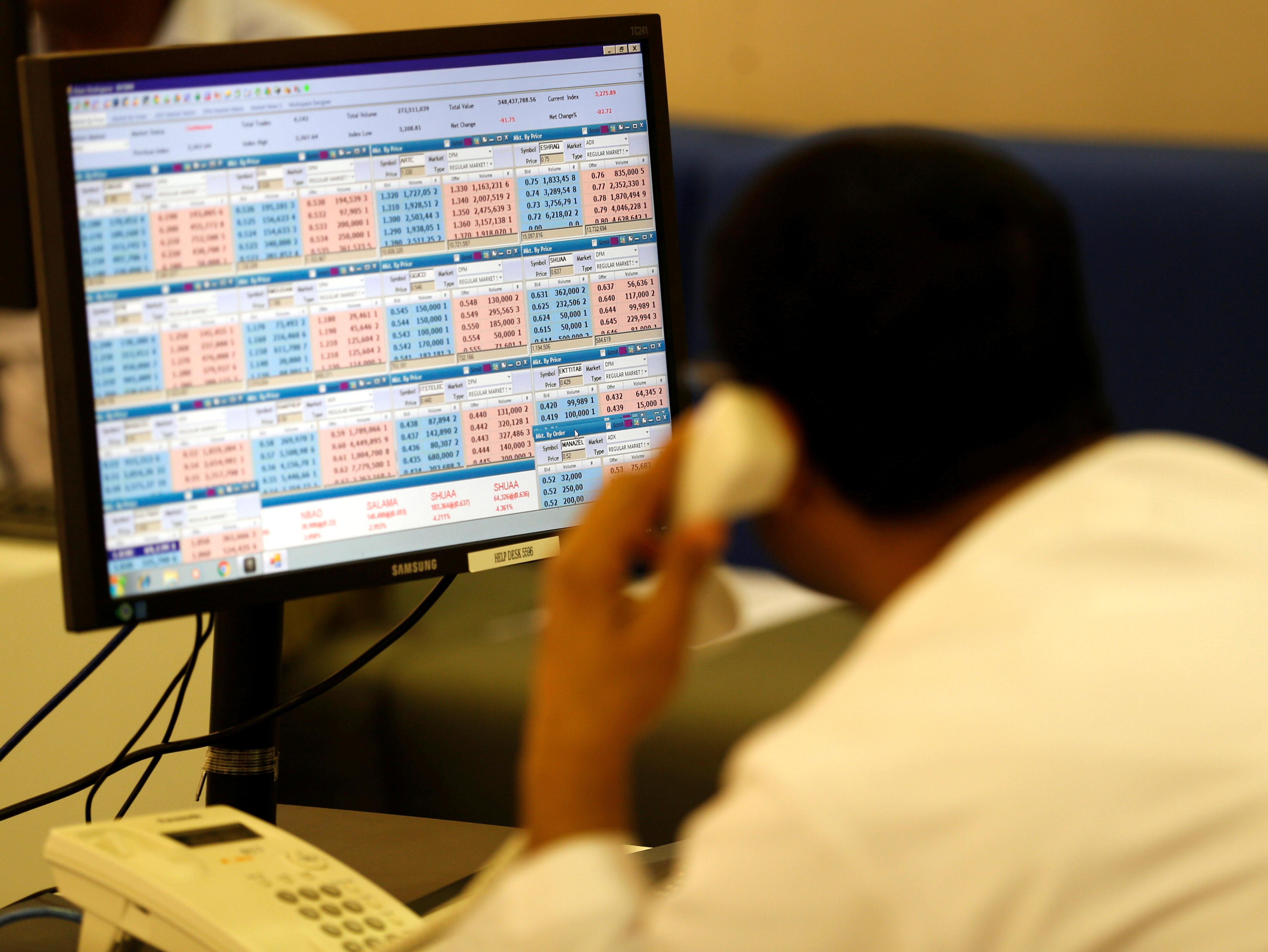 A trader talks on the phone during the opening of the Dubai stock market