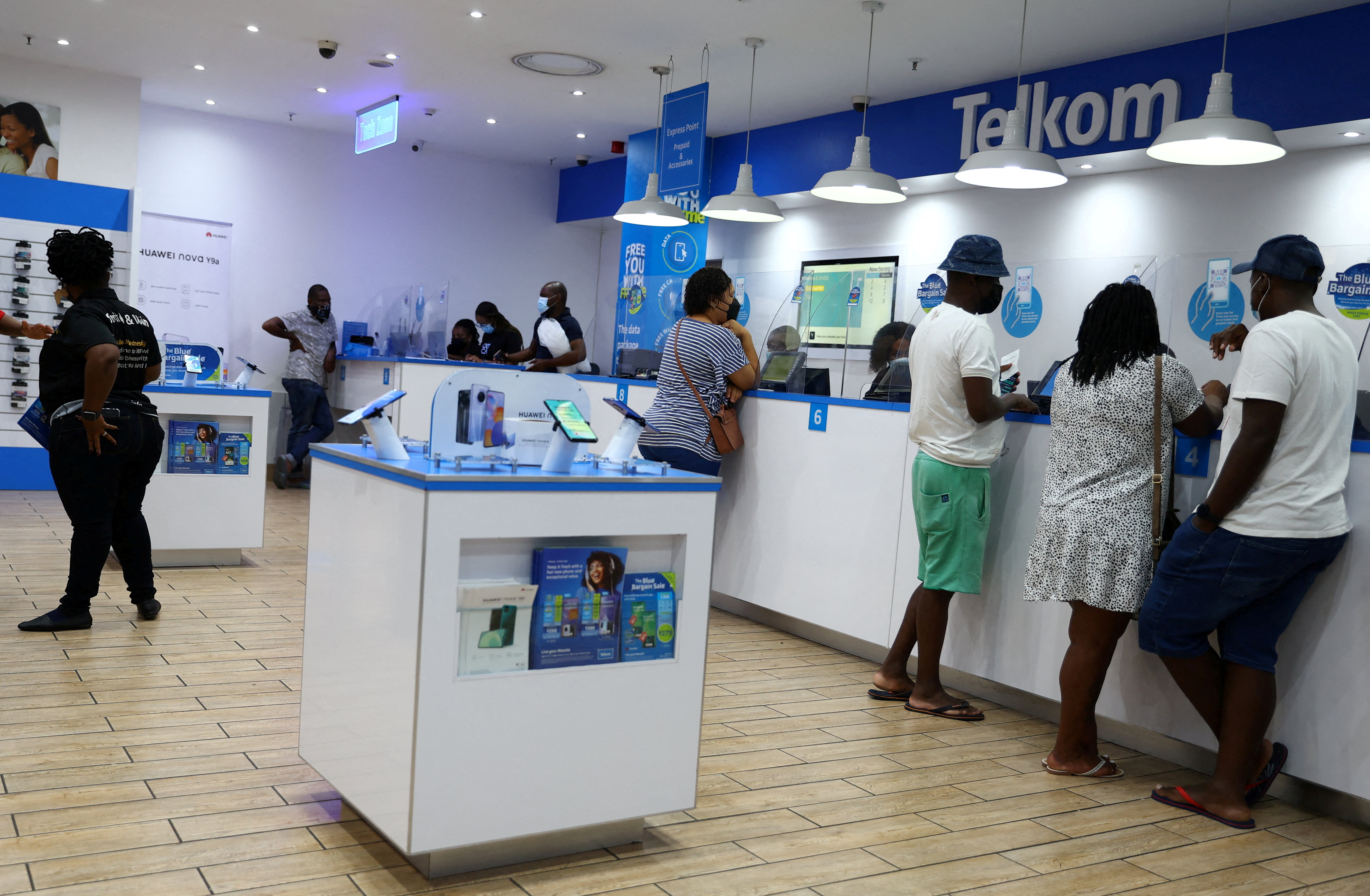 Customers are served at a branch of South Africa's mobile operator, Telkom, in Johannesburg