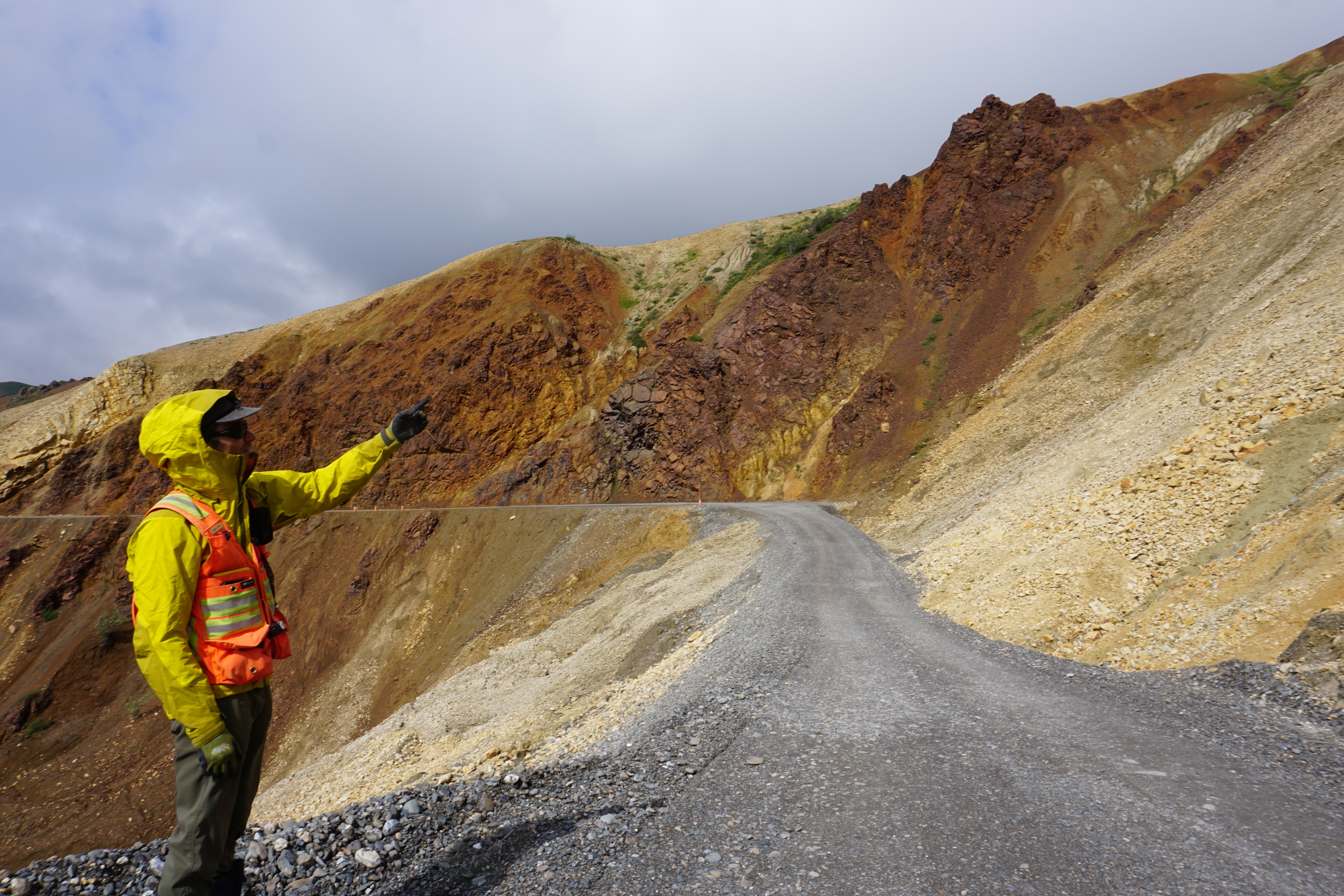 Geologist Denny Capps points out the unsteady terrain that has been thawing and sliding more frequently at the Pretty Rocks site in Denali National Park